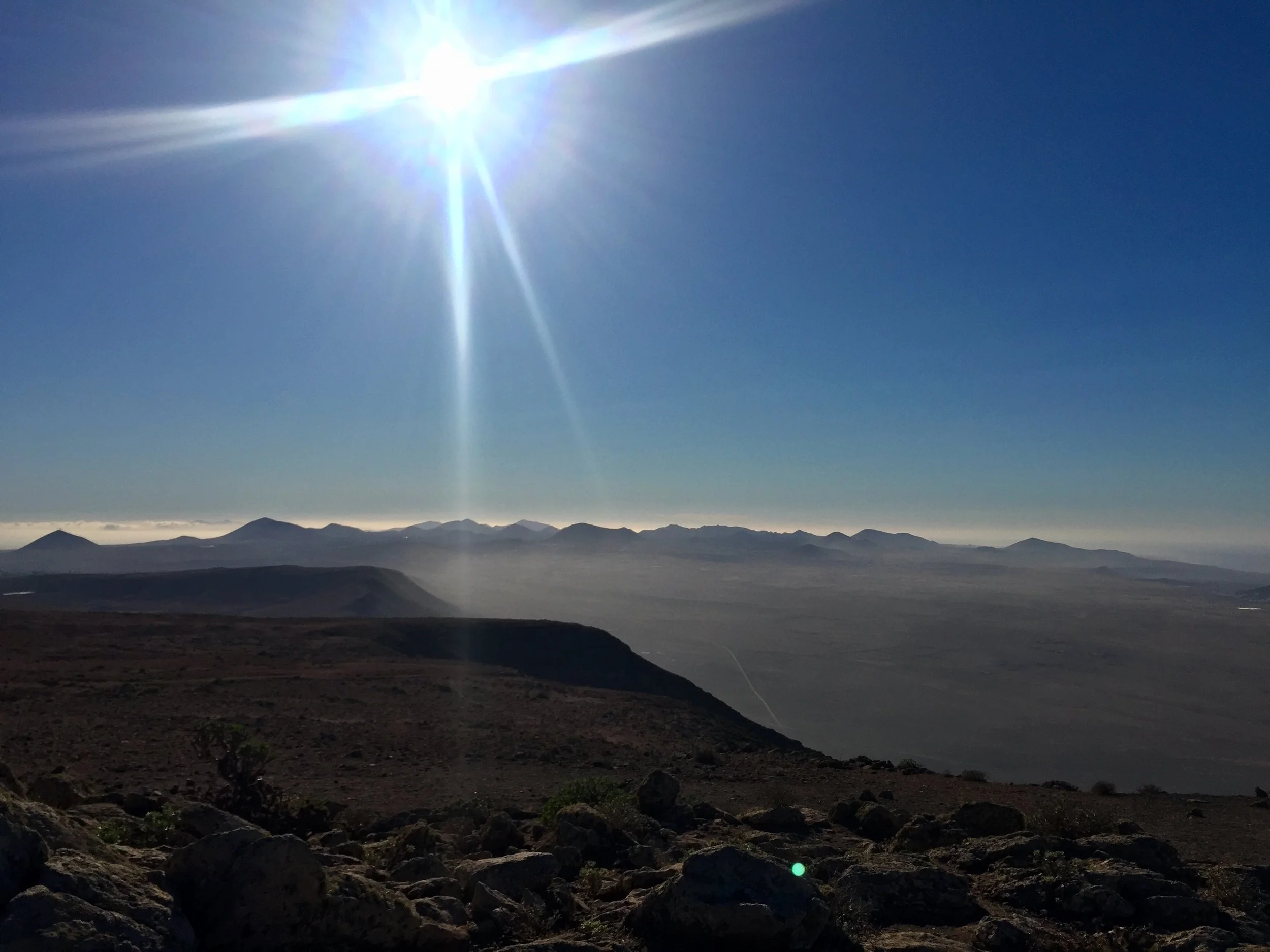 Panoramic view across Lanzarote's volcanic landscape and mountain ranges