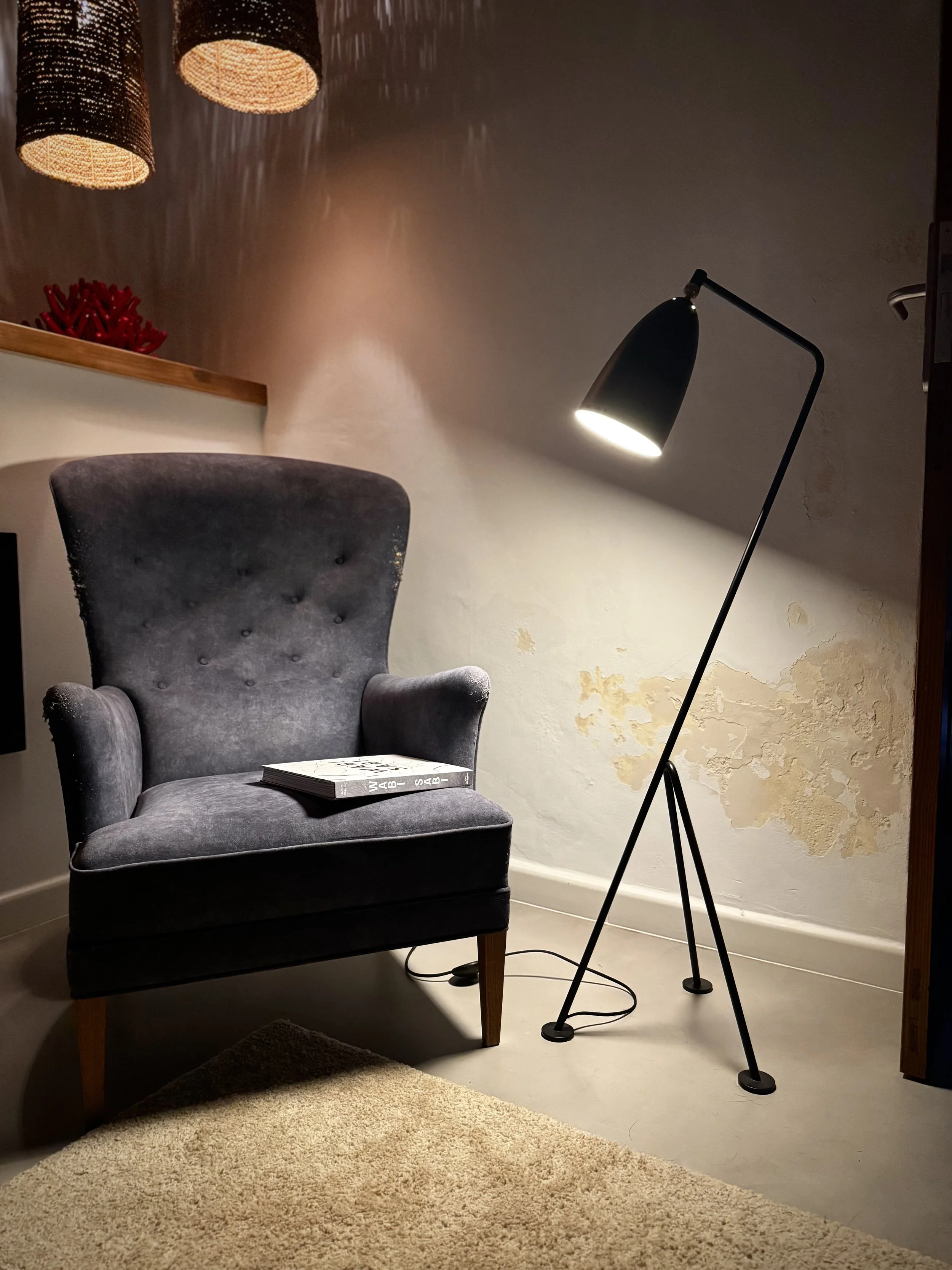 Reading corner with a weathered plaster wall inspired by wabi-sabi in Lanzarote.