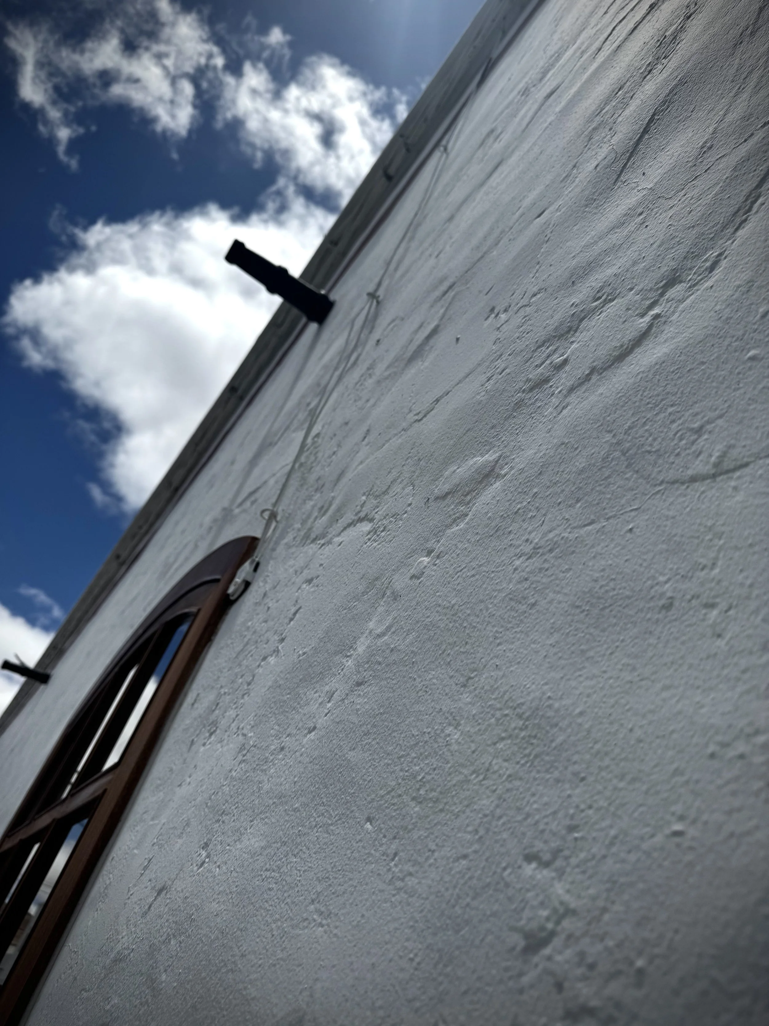 Historic whitewashed exterior wall of a traditional Lanzarote building.