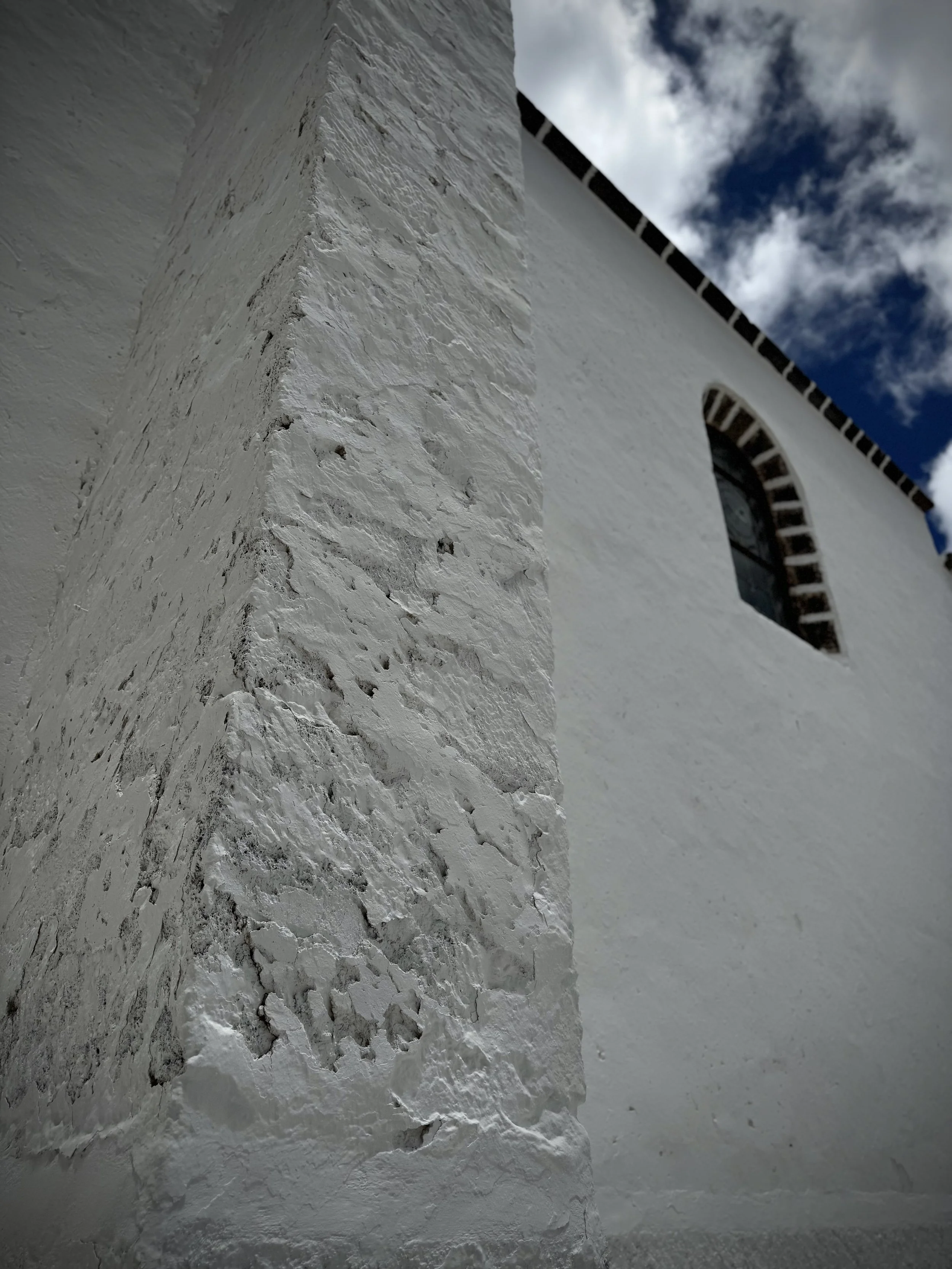Whitewashed church facade in Guatiza with traditional Canarian architecture.