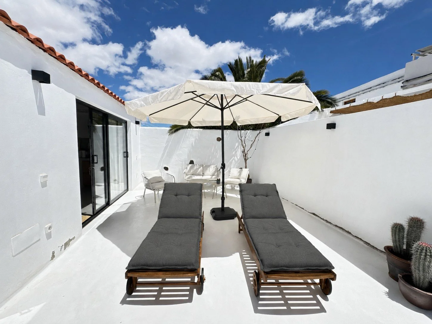 Sun loungers at sunny patio Casitas Santa Rita Lanzarote