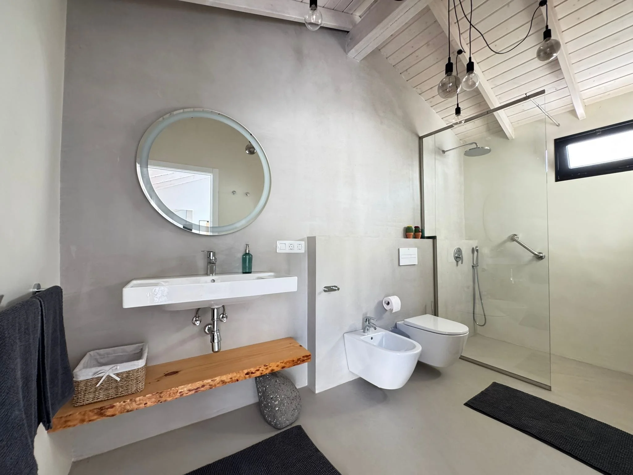 spacious modern bathroom with walk-in shower and bidet