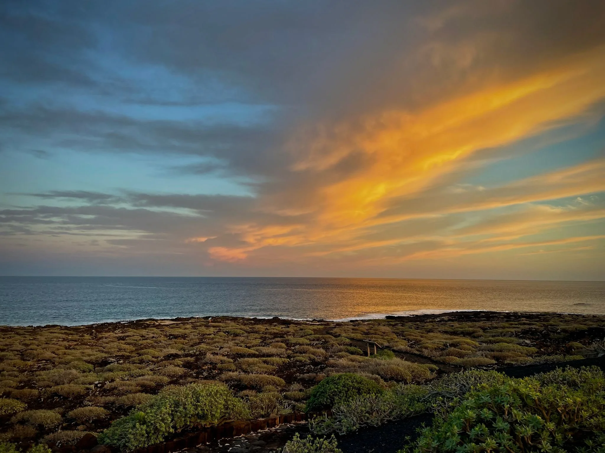 Sandy coastal path along the volcanic shoreline of Lanzarote