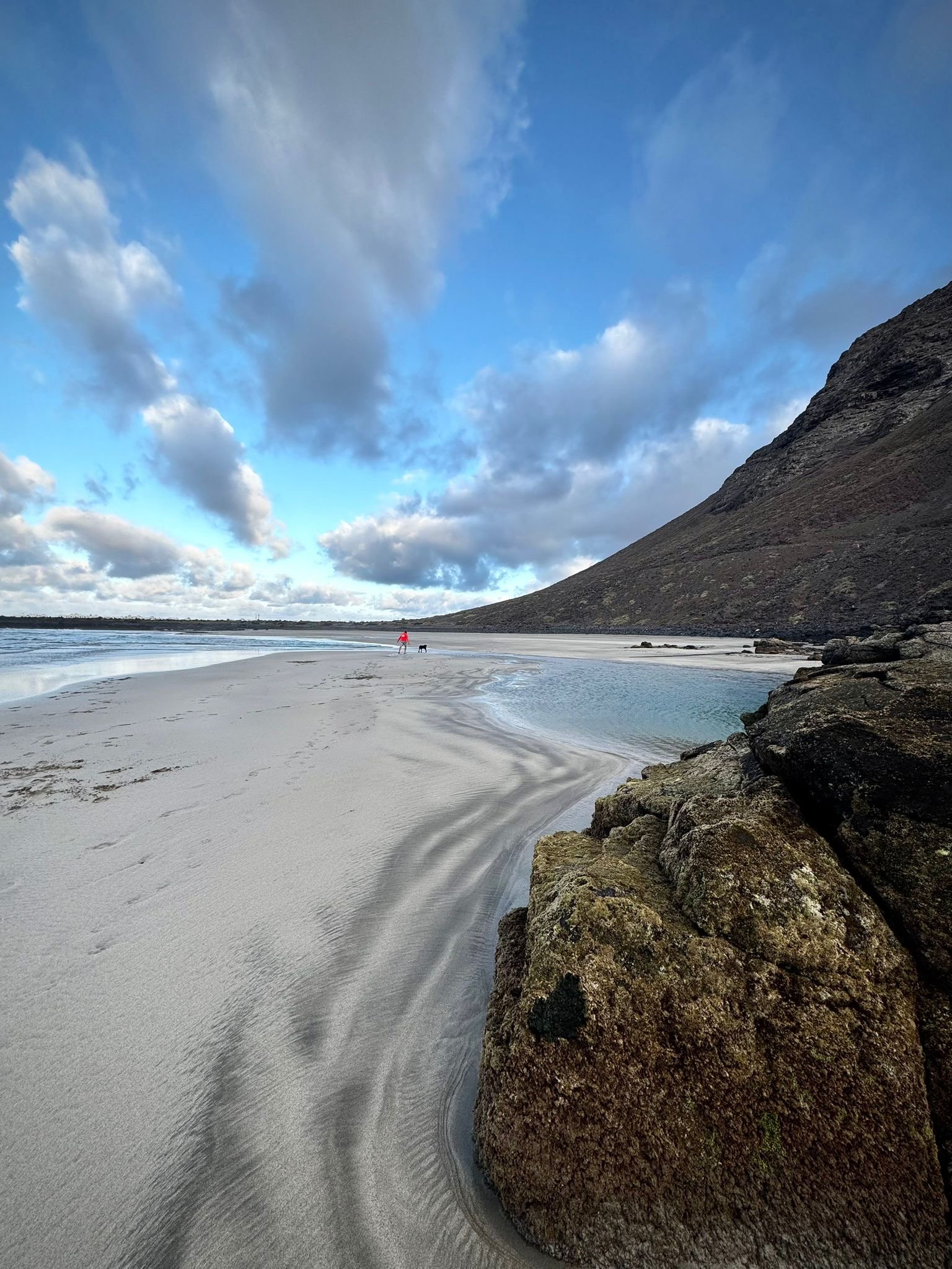 Hidden shoreline revealed by low tide at Playa de Las Canteras on Lanzarote.