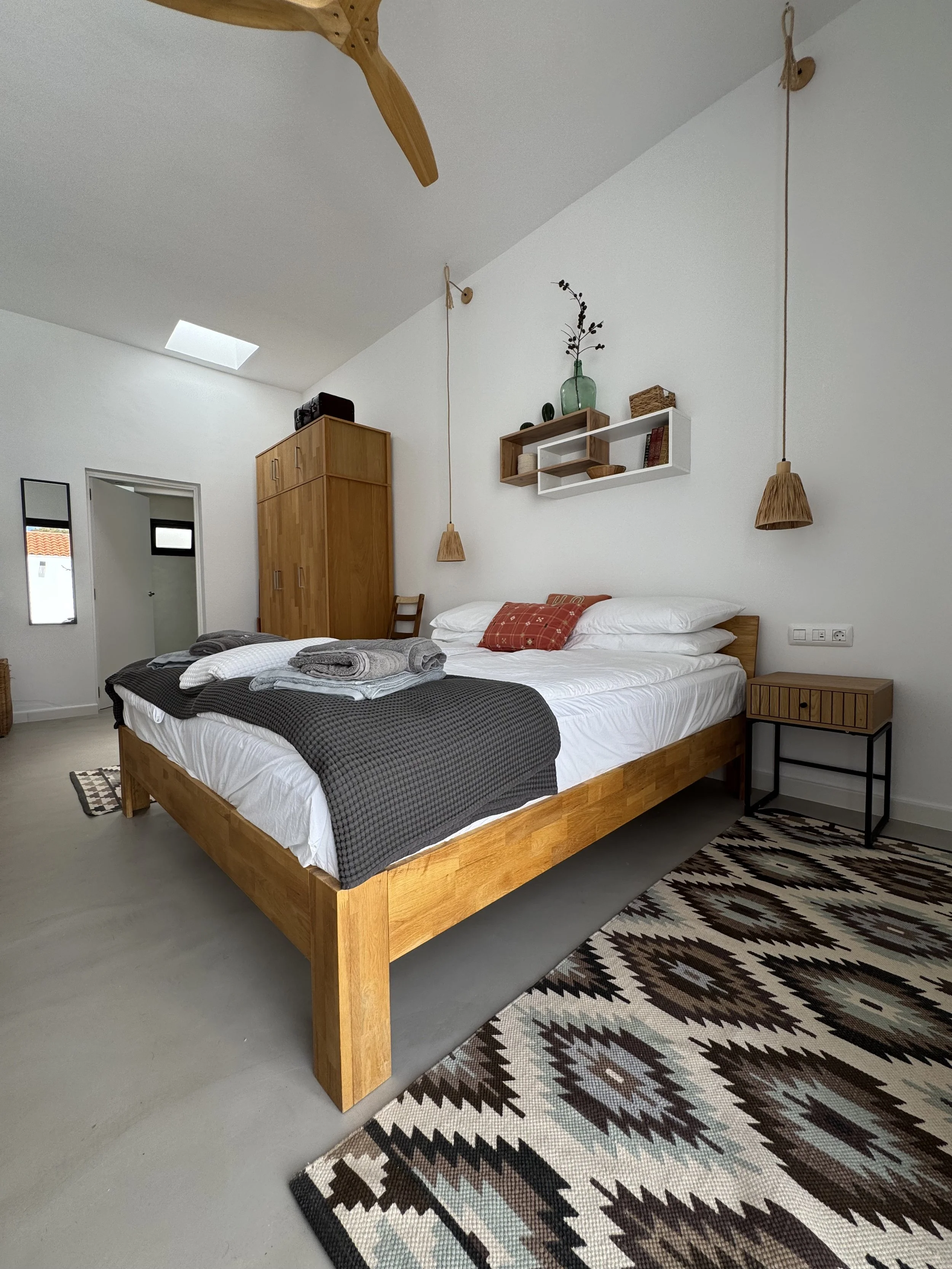 Bedroom with natural wood furniture and soft daylight at Casita Luna Lanzarote