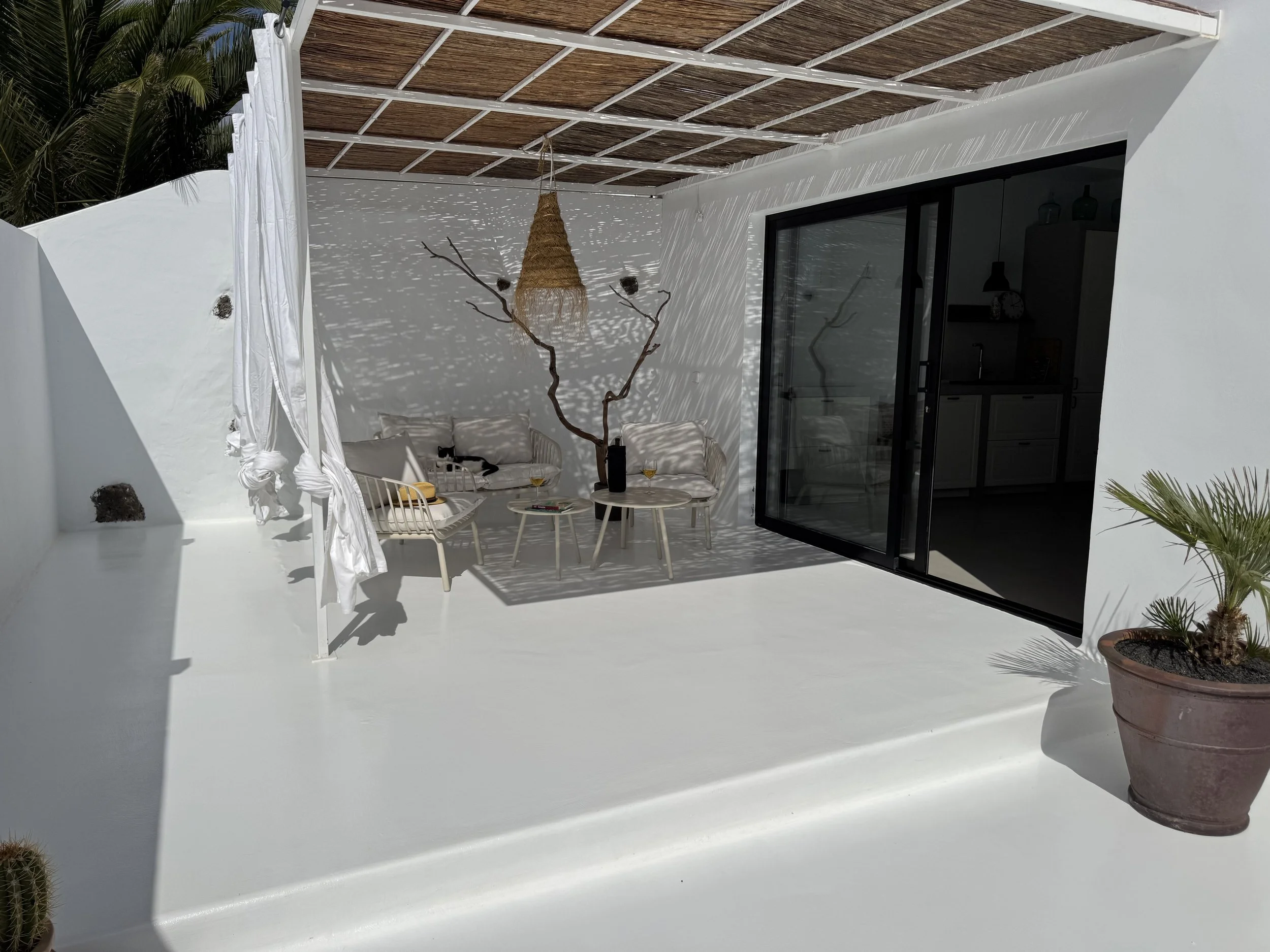 Private terrace with white architecture and woven pergola at Casita Luna Lanzarote