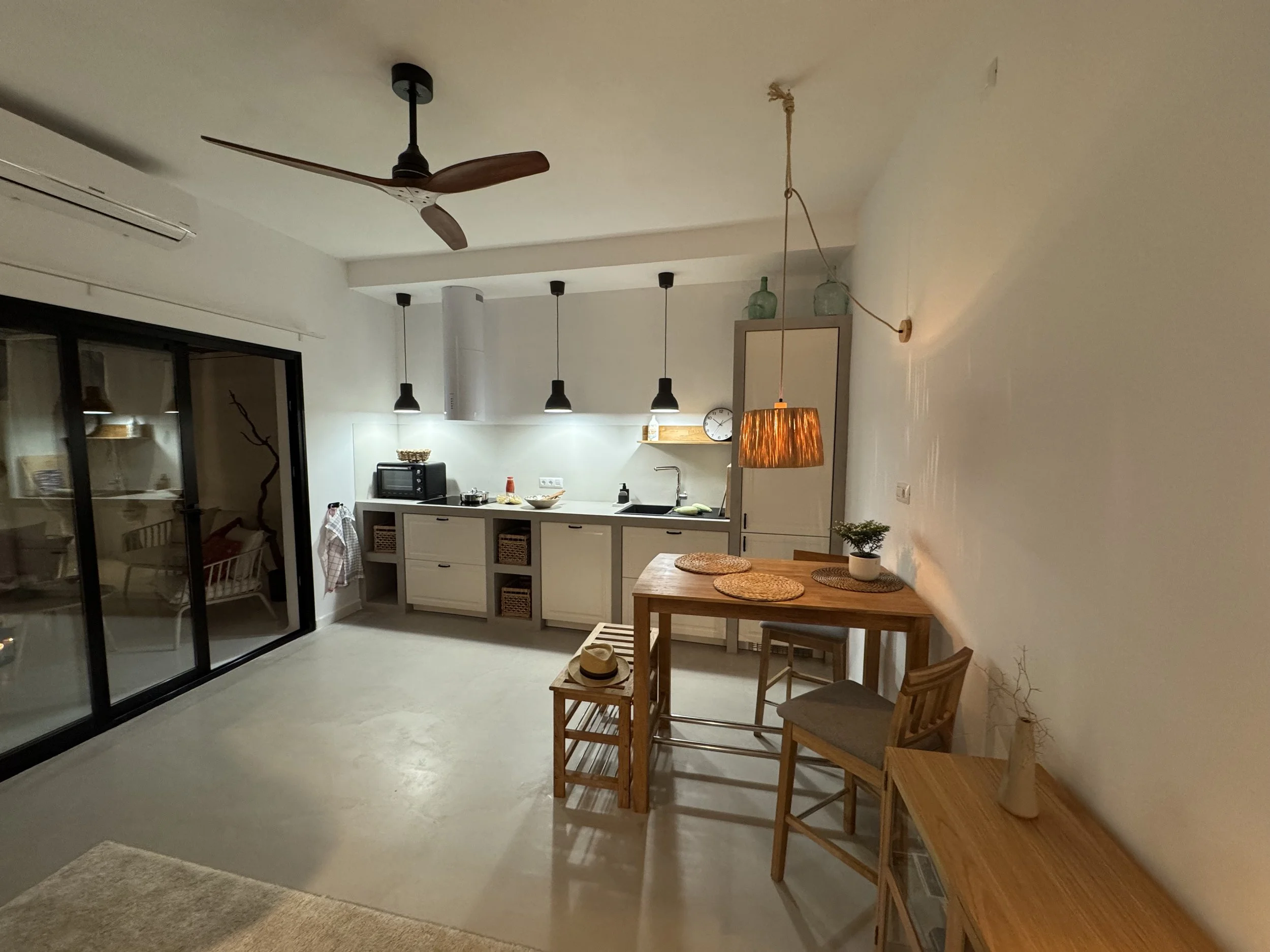 Cozy kitchen and dining area in warm evening light at Casita Luna Lanzarote