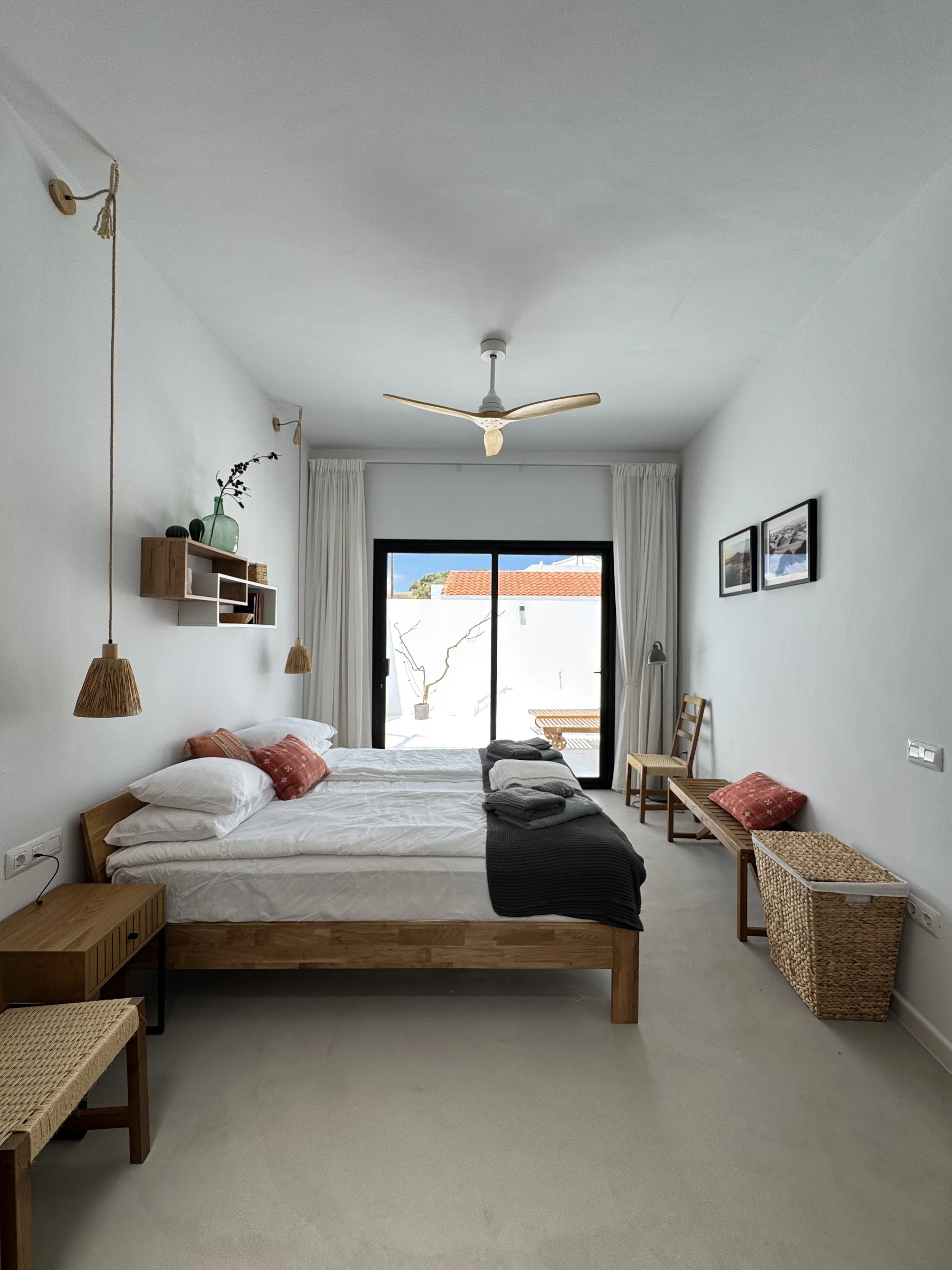 Bright boutique bedroom with private patio access at Casita Luna Lanzarote