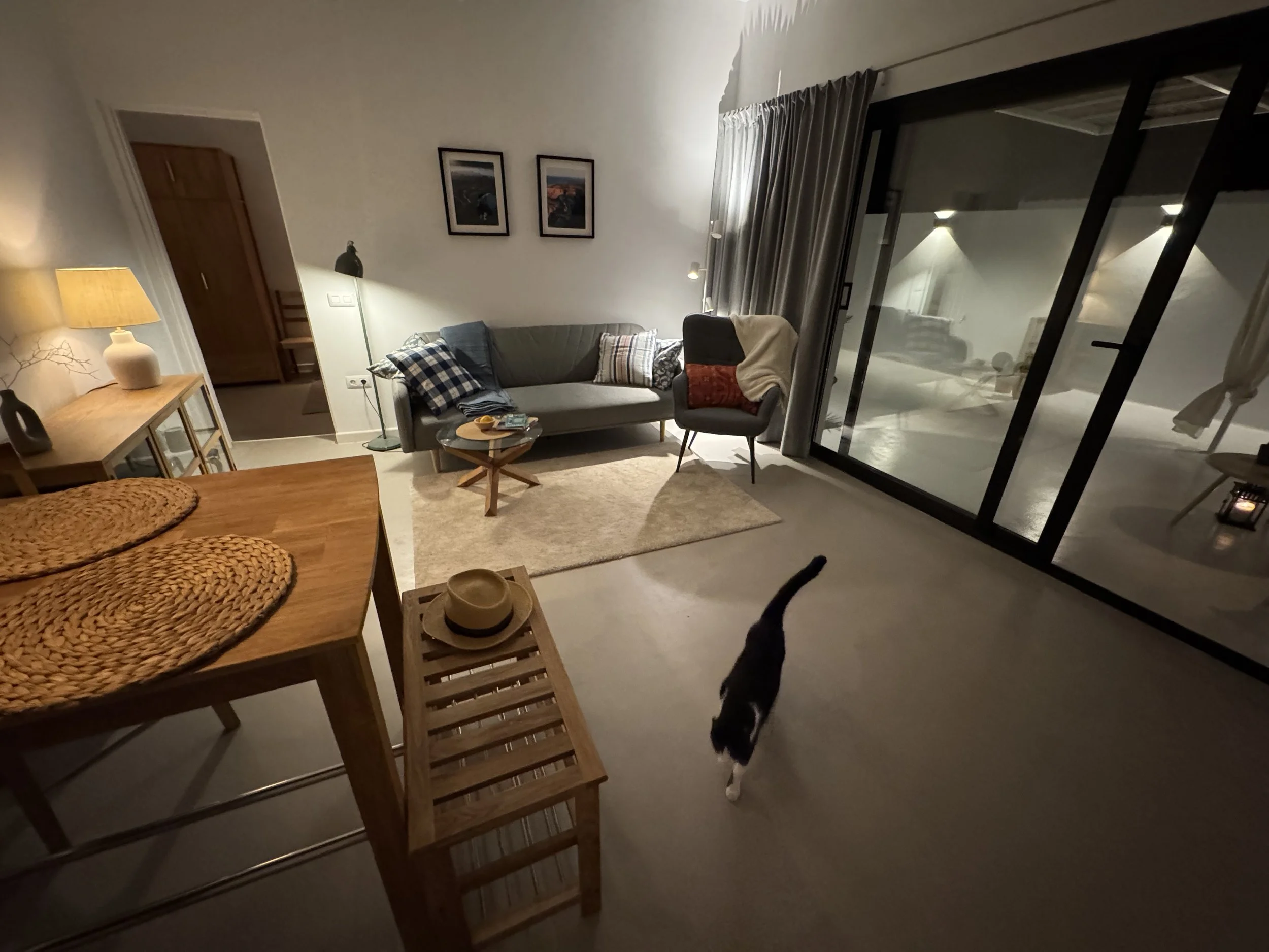 Minimalist bathroom with round mirror and bedroom view at Casita Luna Lanzarote