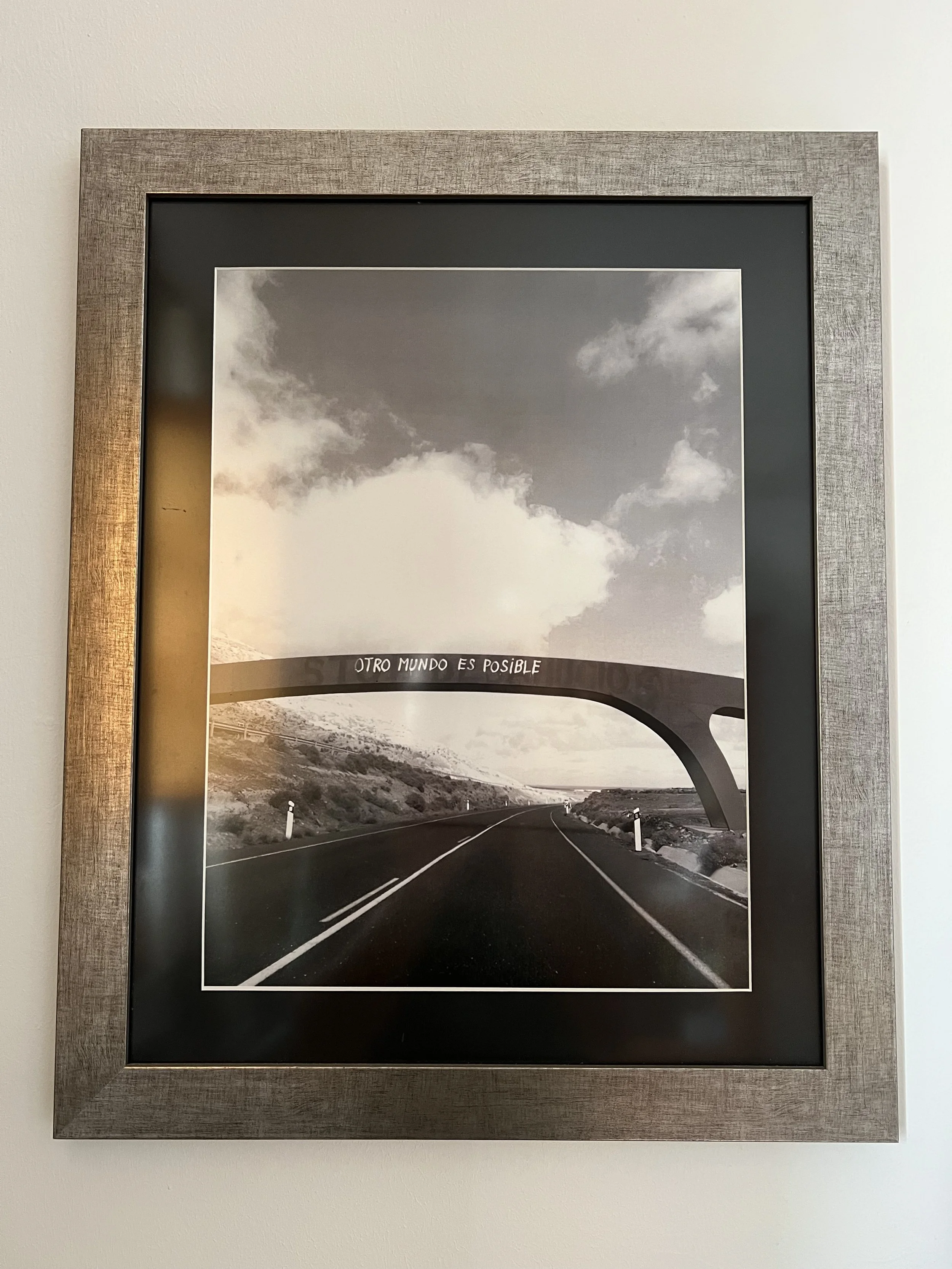 Framed photograph of the Otro Mundo es Posible bridge in Lanzarote hanging in our home