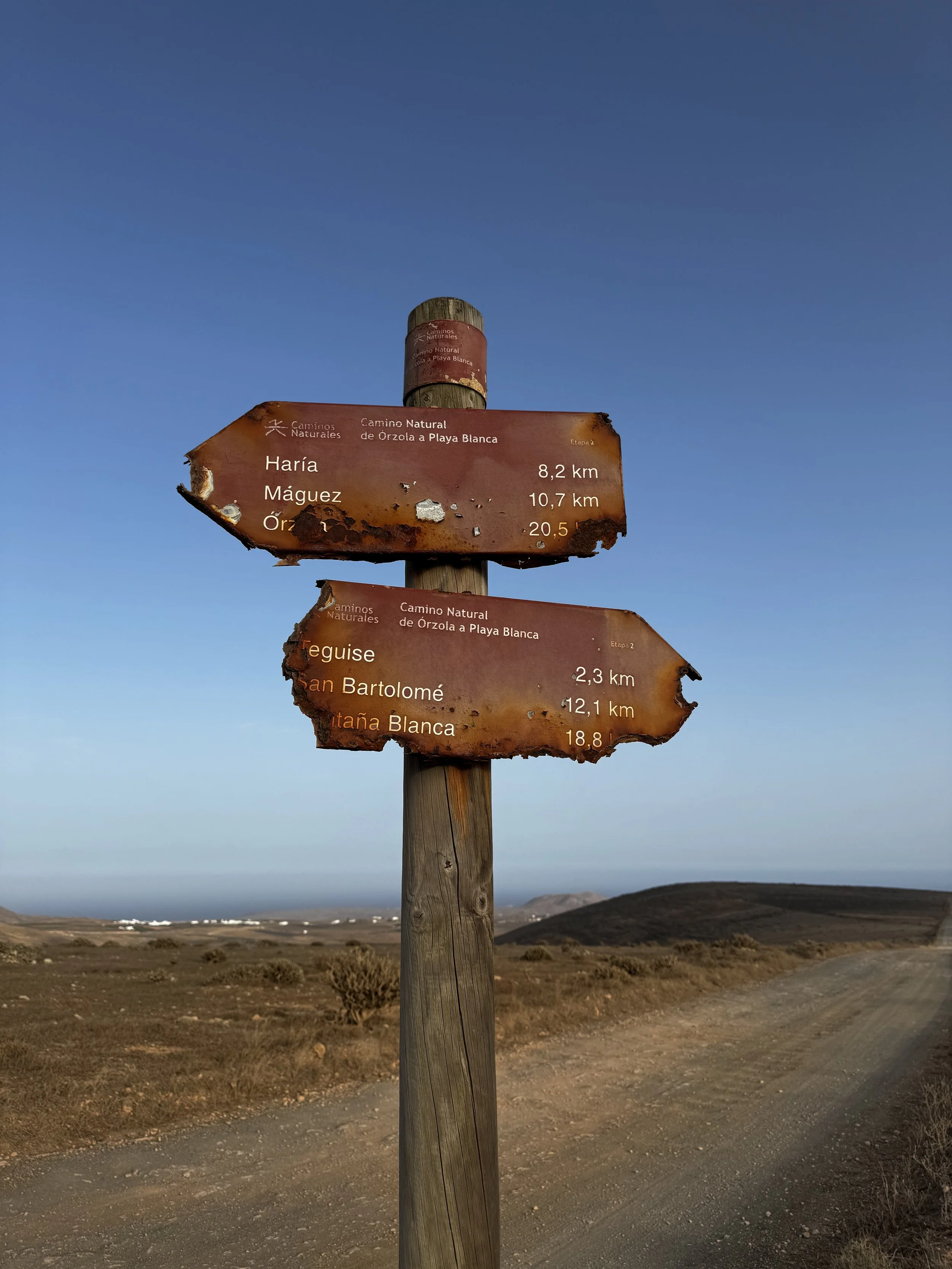 Weathered Camino Natural sign pointing towards hidden corners of Lanzarote.