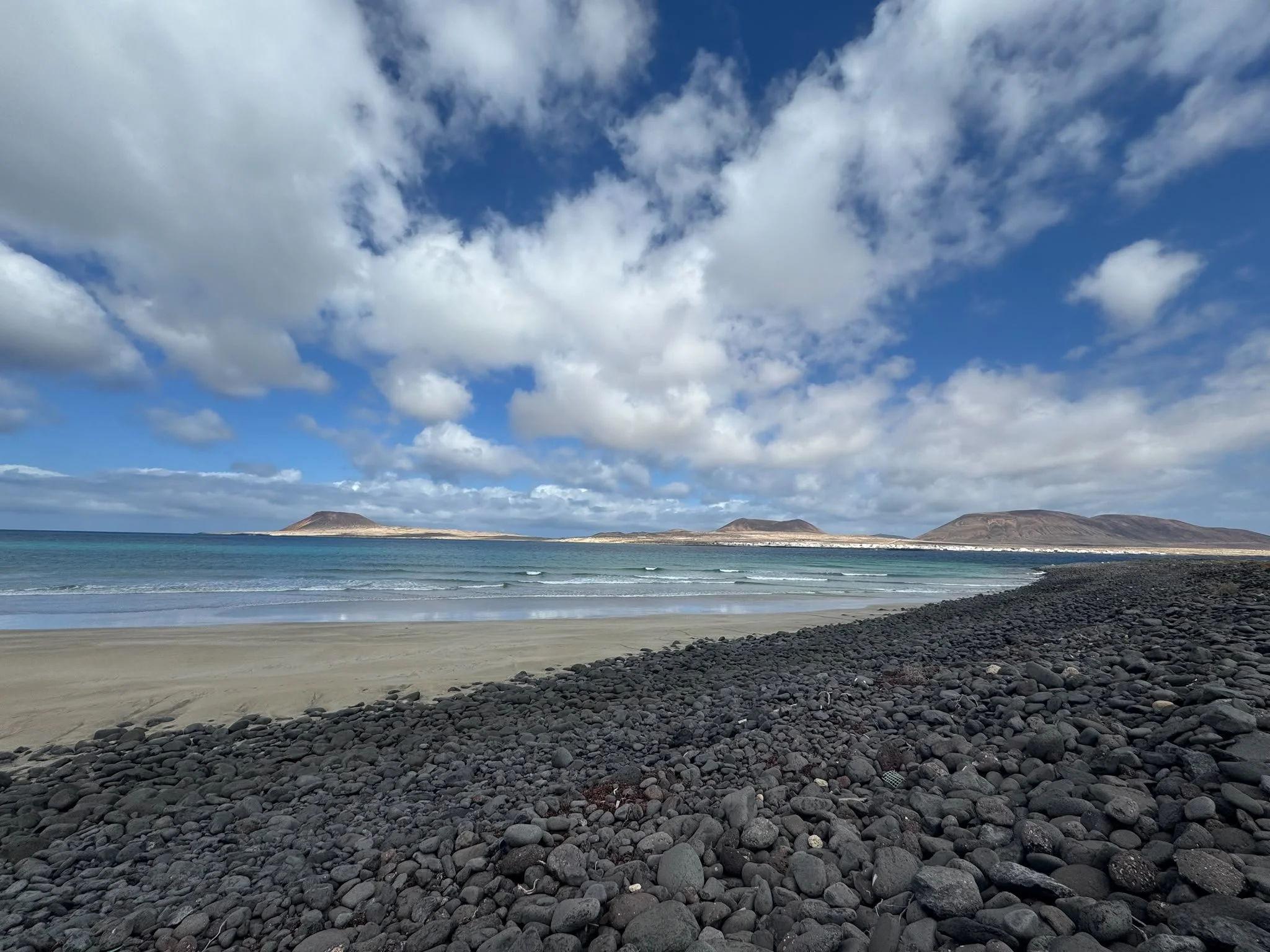 Rocky shoreline at Playa del Risco with views of La Graciosa