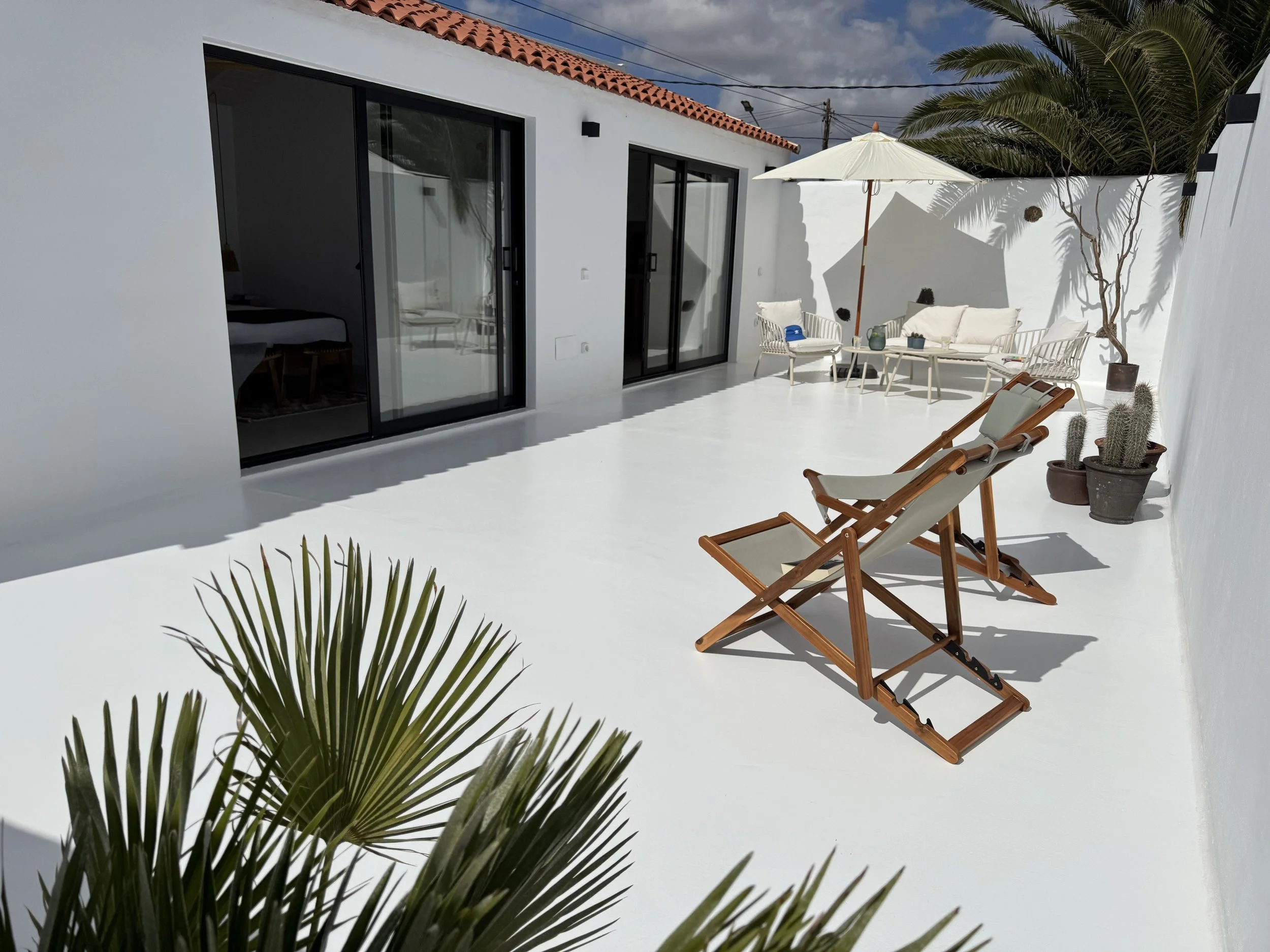 Private terrace at Casita Coco Lanzarote with sun loungers and minimalist white architecture