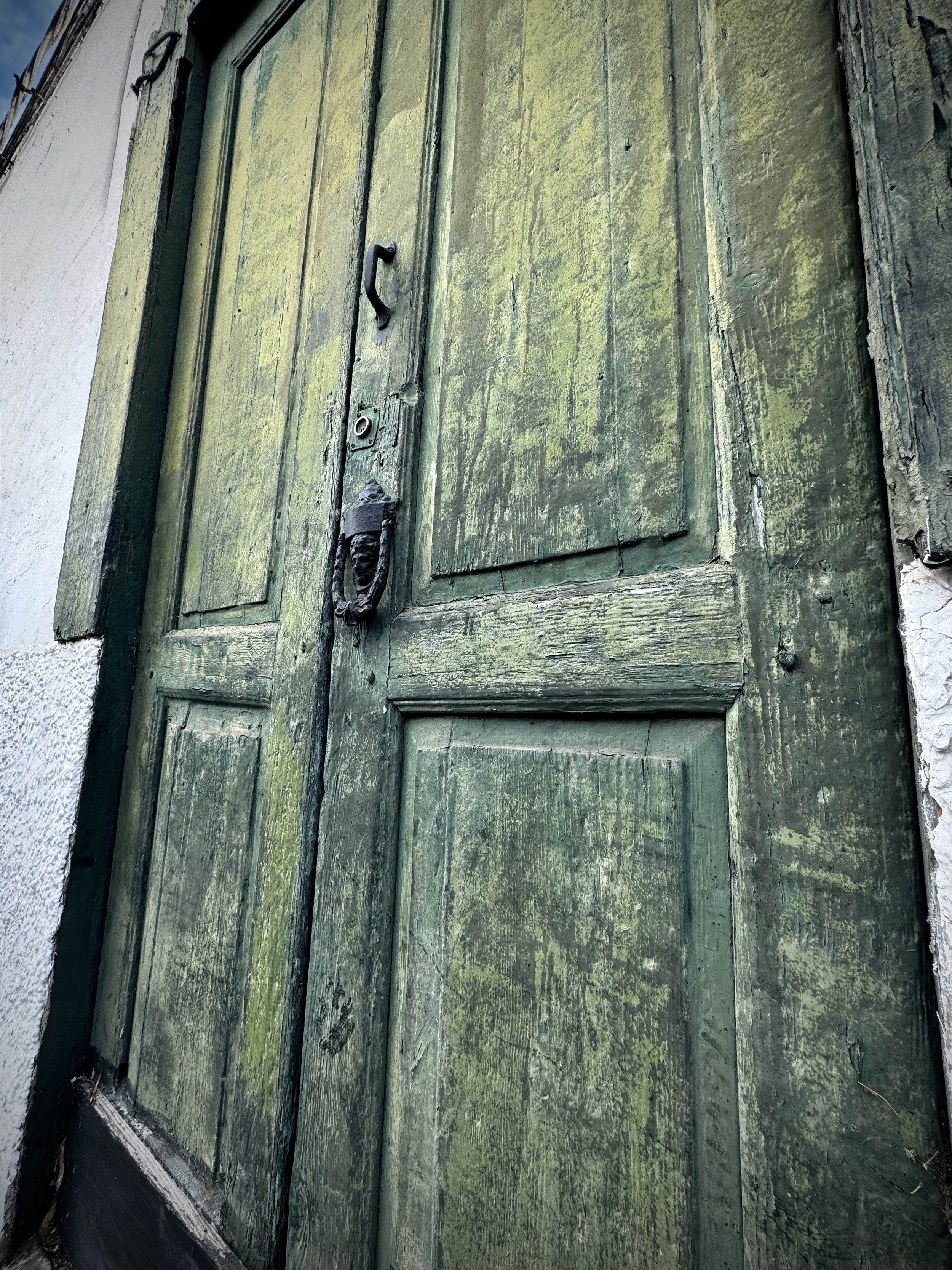 Old green wooden door shaped by time in Guatiza, Lanzarote.