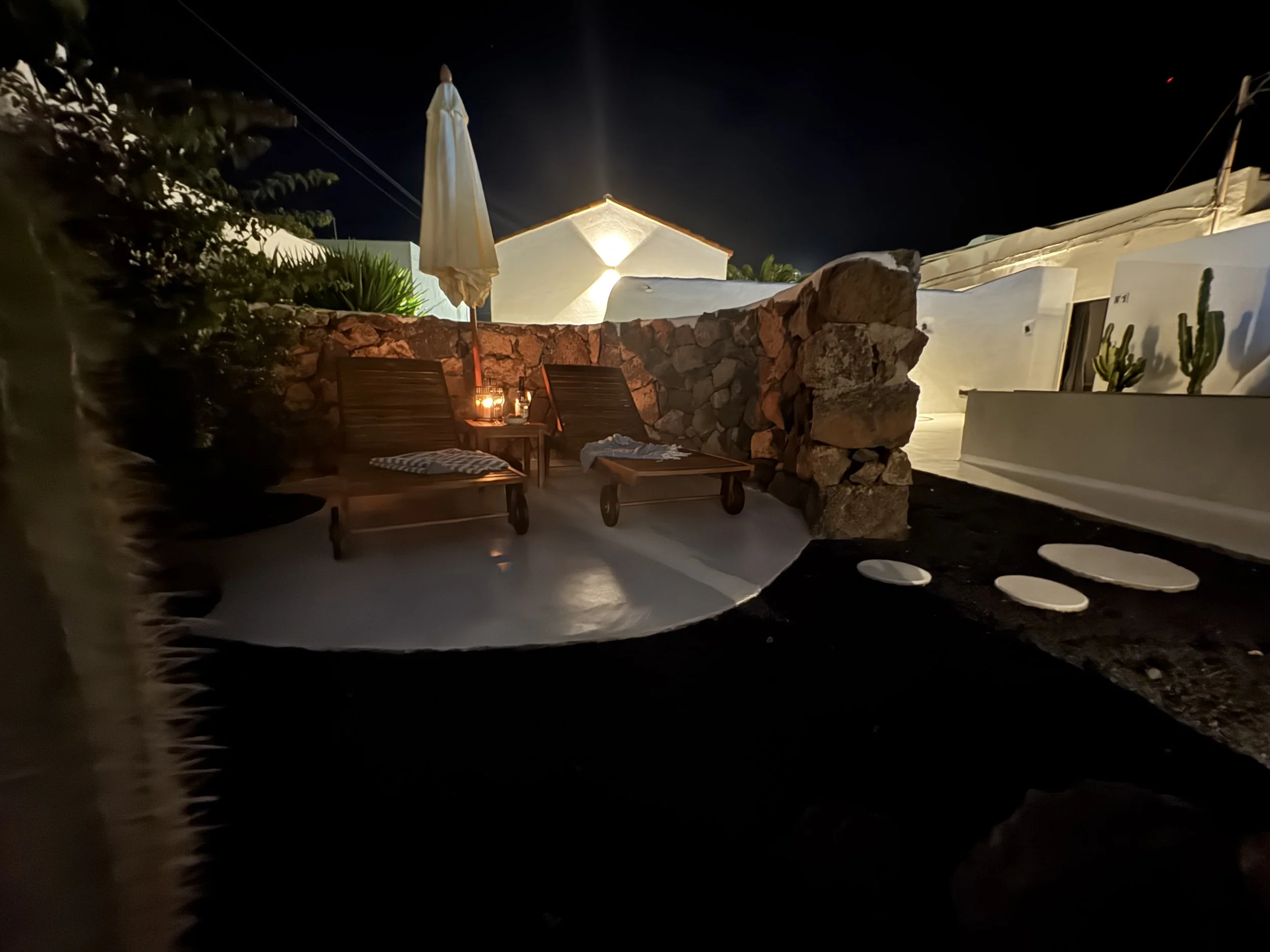 Romantic patio with loungers and volcanic garden at night in Lanzarote