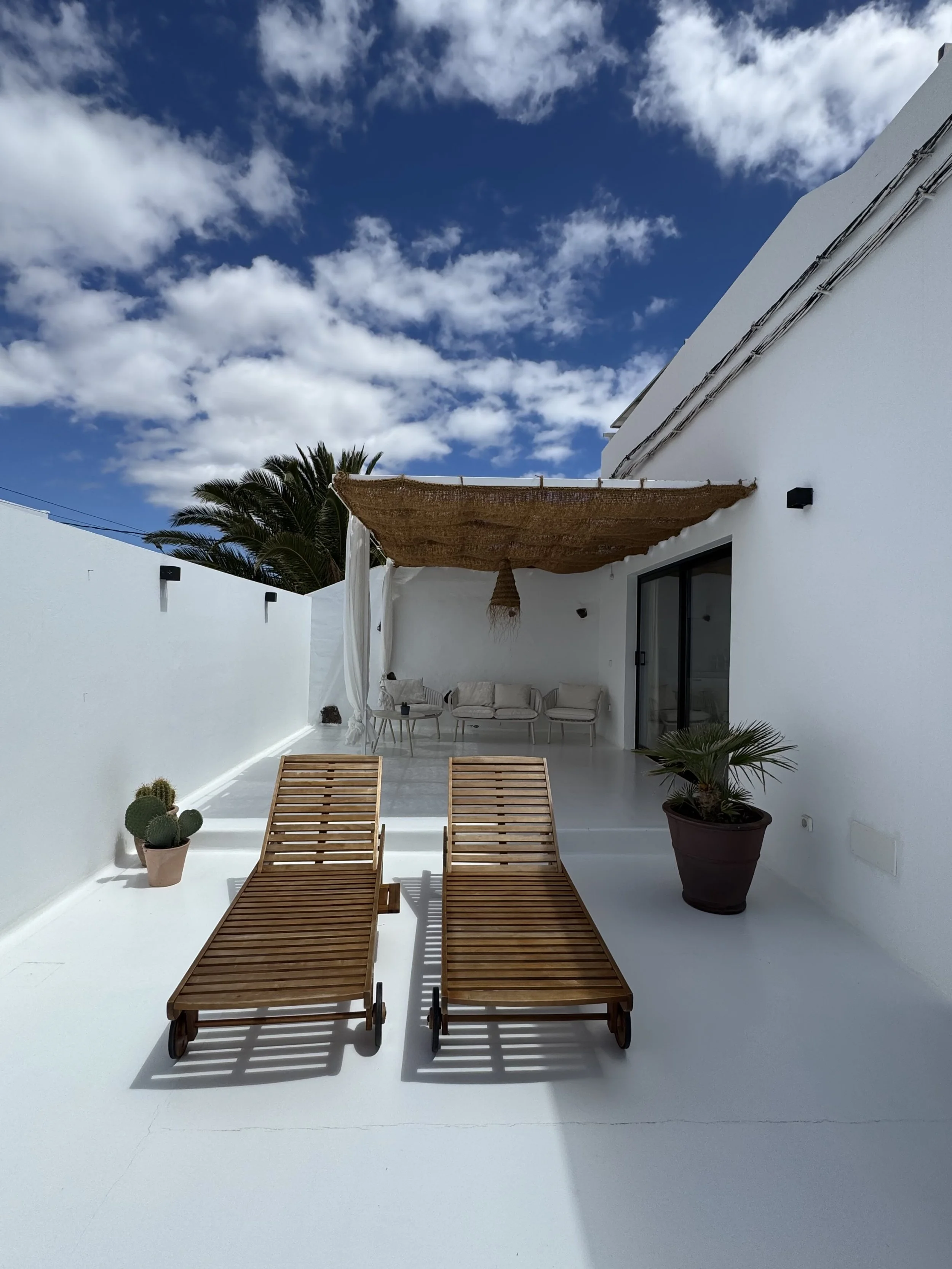 Bright private terrace with wooden loungers at Casita Luna Lanzarote