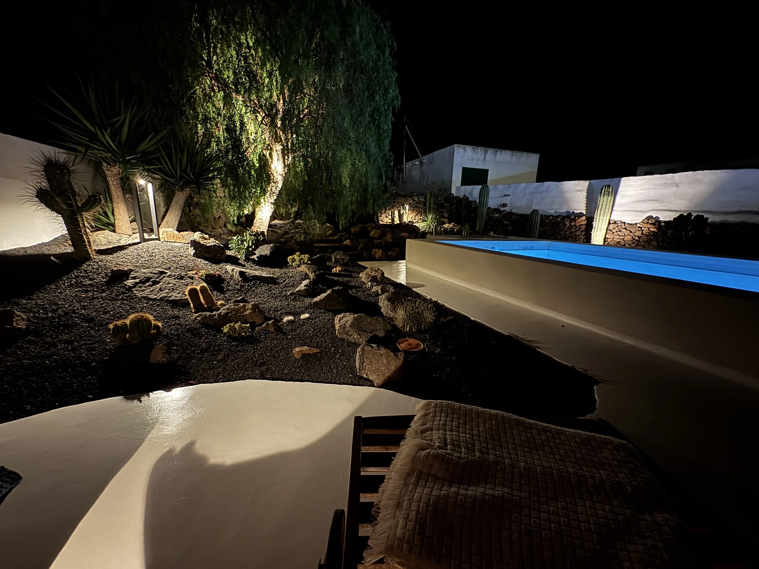 Nighttime pool retreat with loungers and soft lighting in Lanzarote