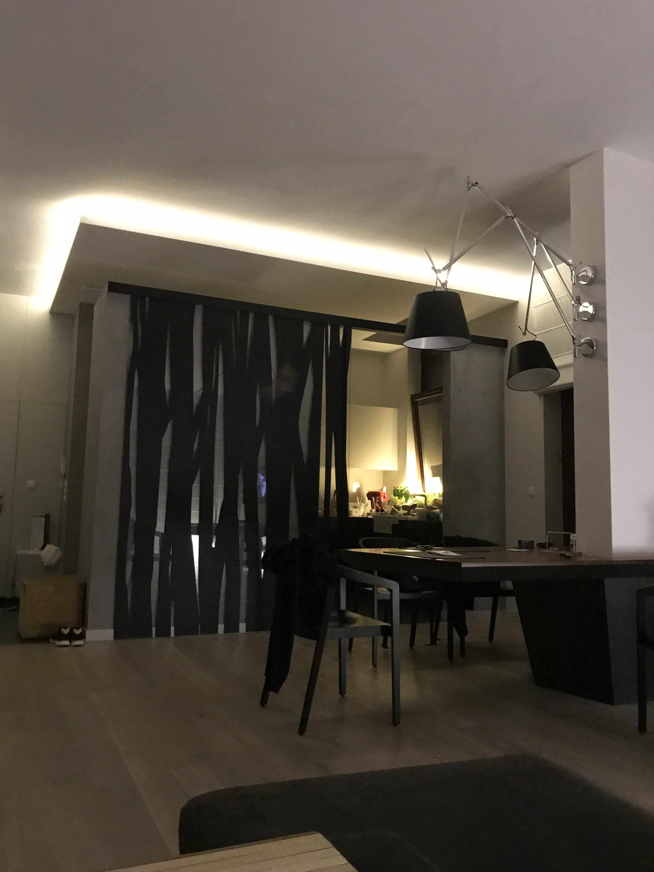 Finished apartment where the dining table was designed around the concrete column.