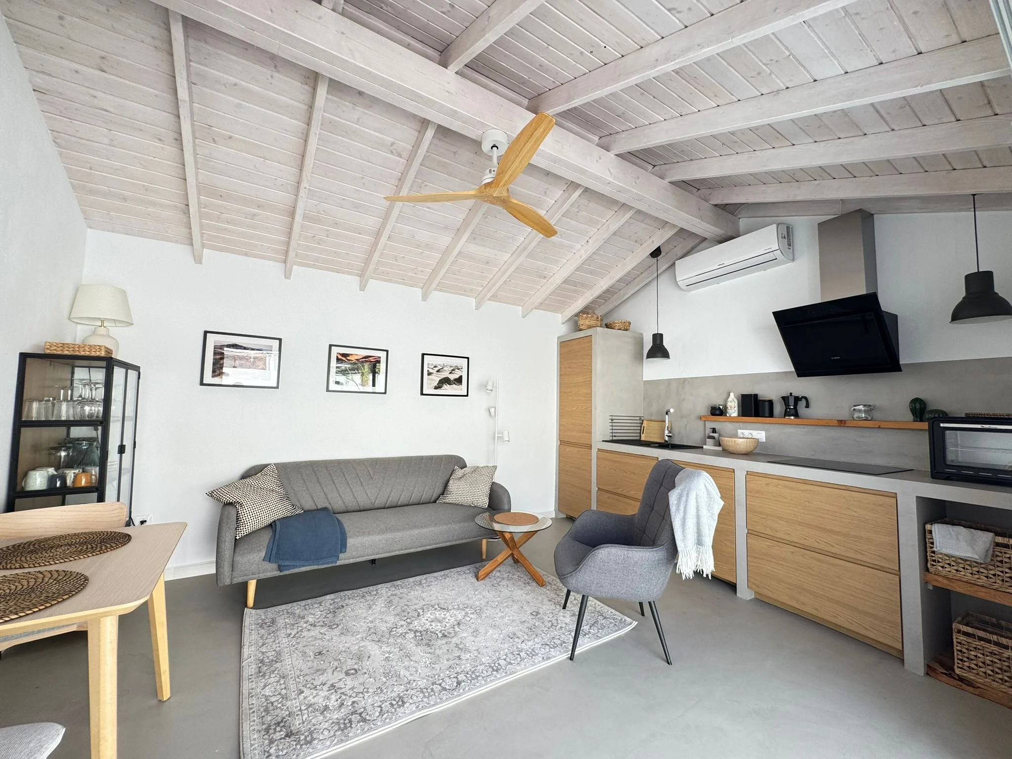 beautiful kitchen-living room with white wooden ceiling
