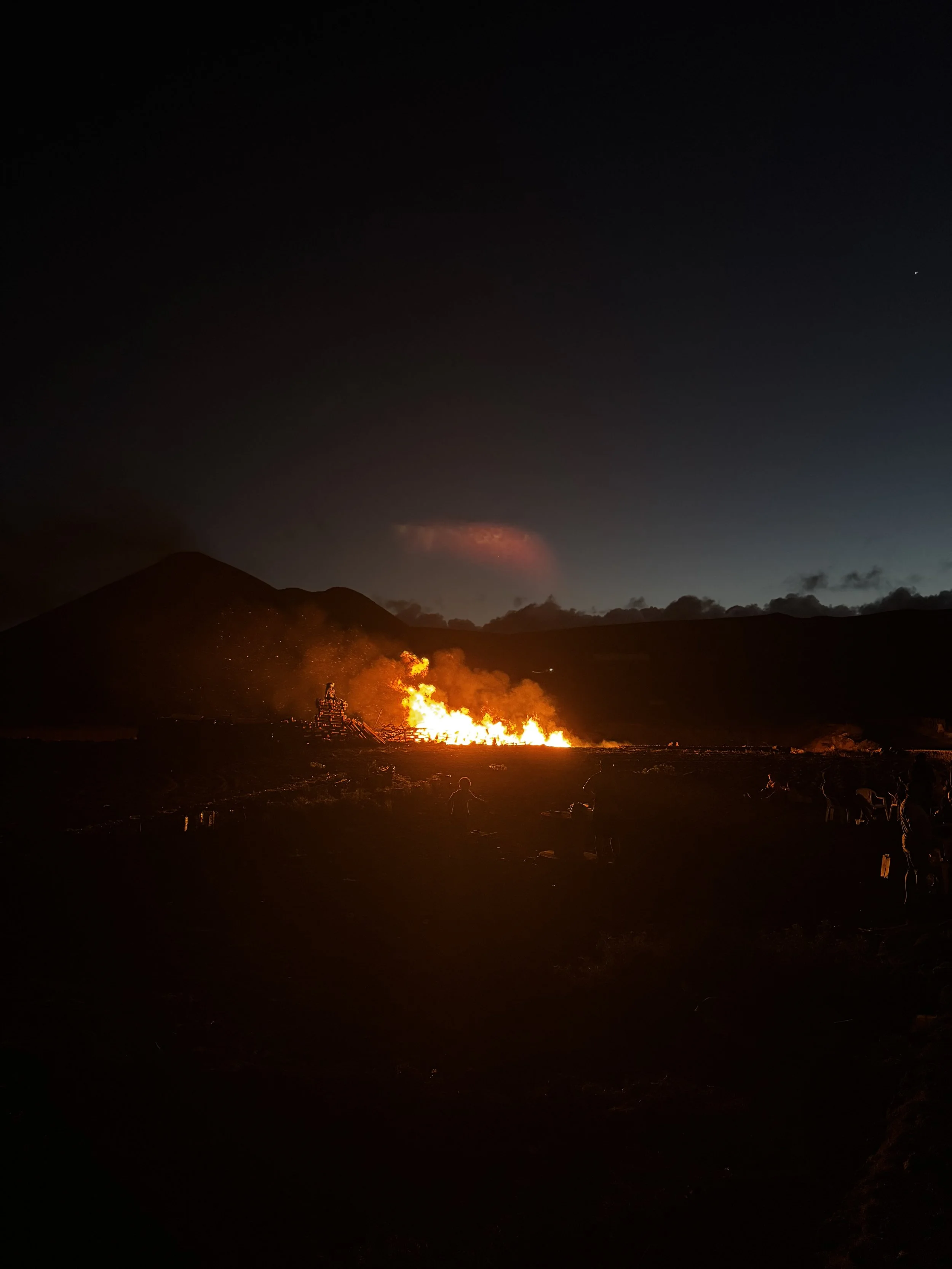 Bonfires begin appearing across Lanzarote as darkness falls on the night of San Juan.