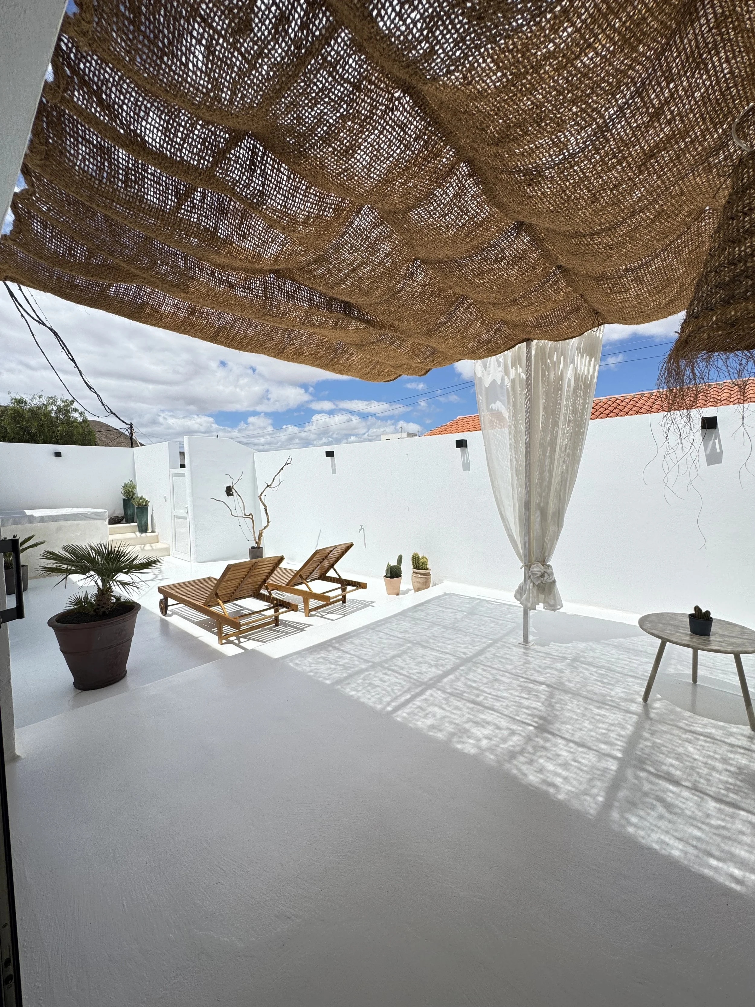 Bright private terrace with sun loungers and white architecture at Casita Luna Lanzarote