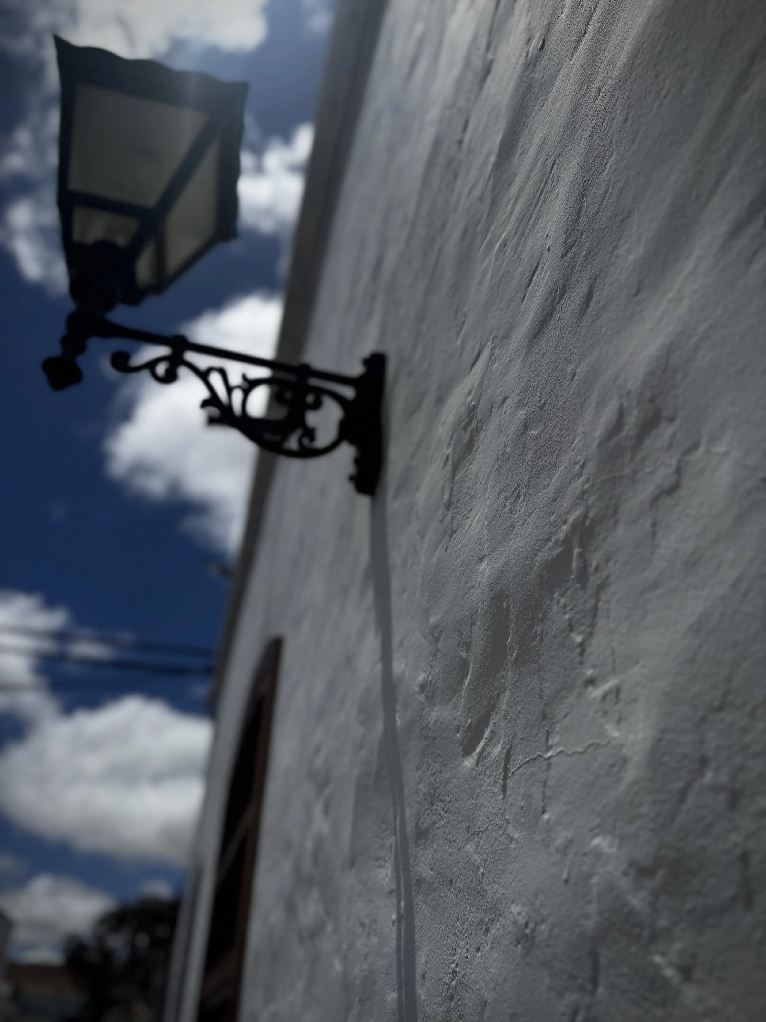 Traditional lantern mounted on an old white wall in Lanzarote.