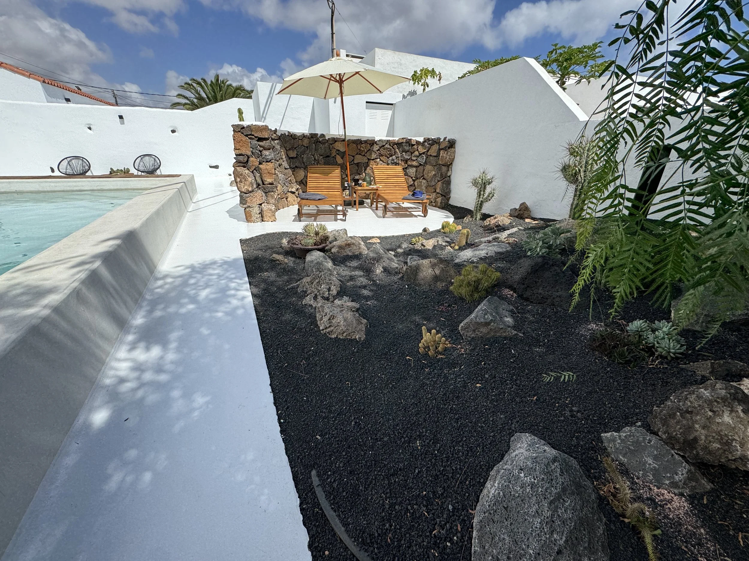 Crystal clear pool water in the peaceful garden of Casitas Santa Rita Lanzarote