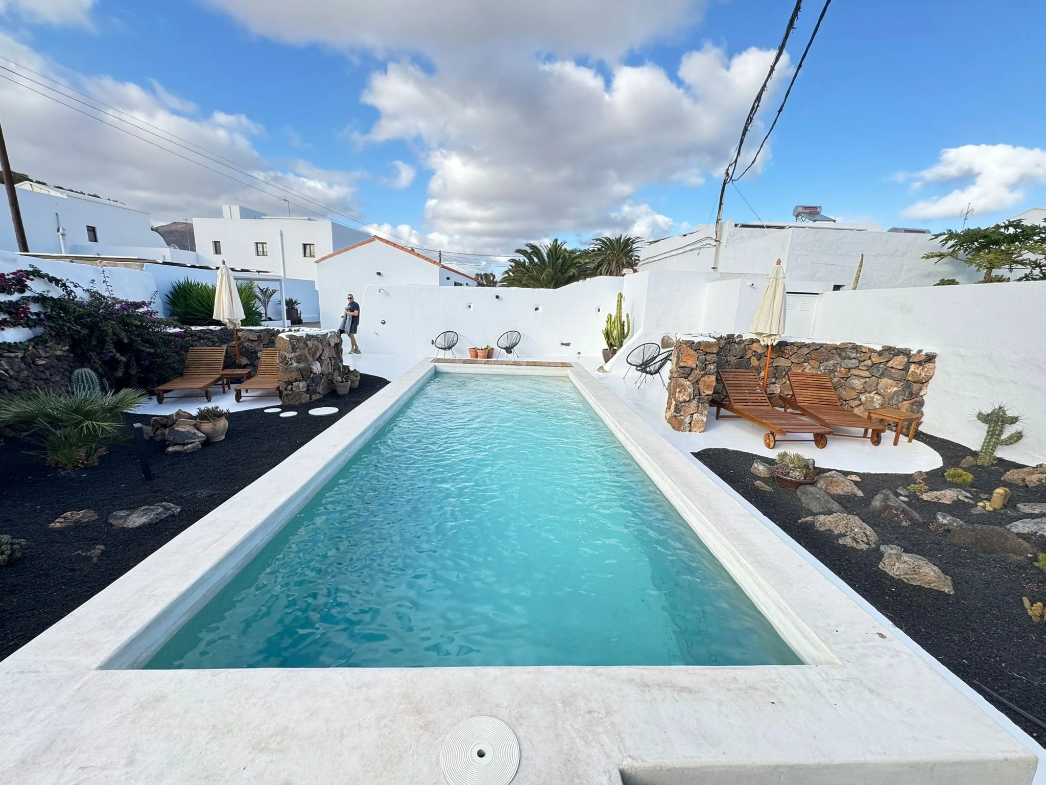 Swimming pool surrounded by volcanic gardens at Casitas Santa Rita