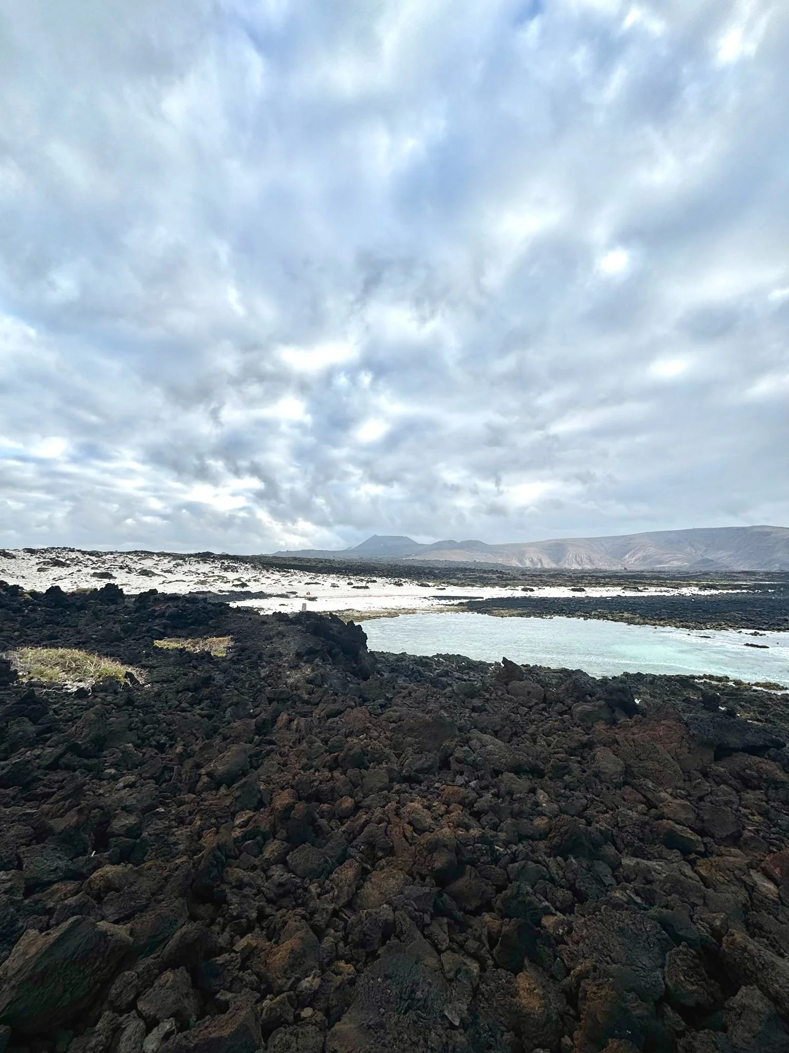 Hidden beach between volcanic rocks in northern Lanzarote