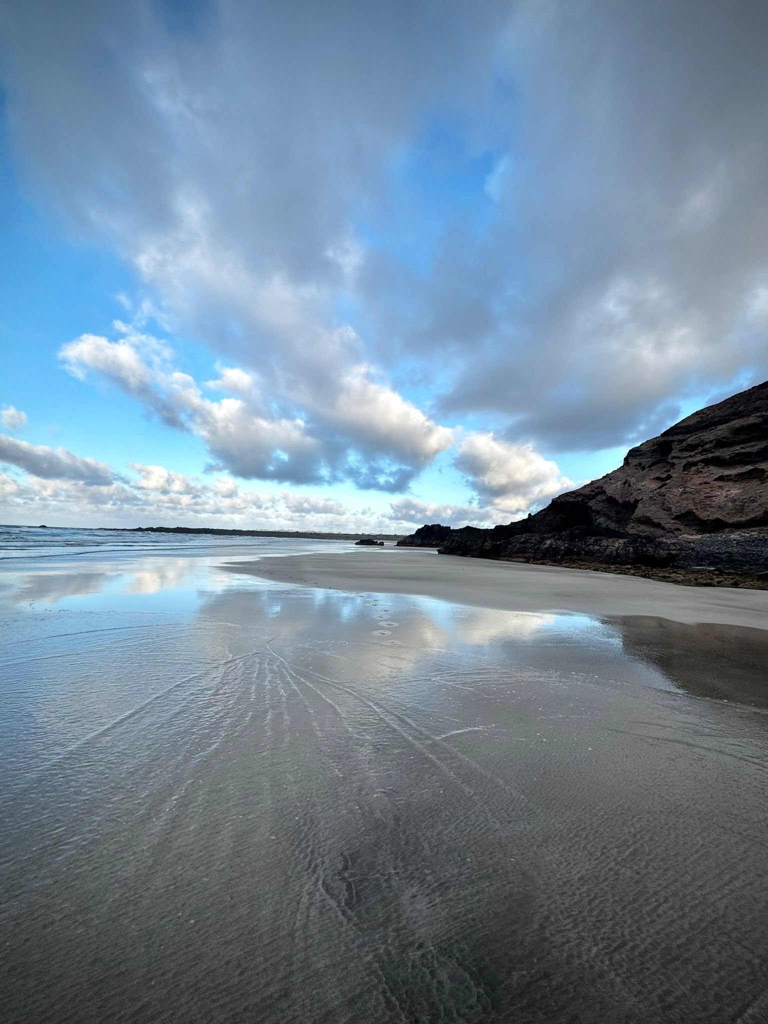 An extraordinary low tide at Playa de Las Canteras reveals reflections, textures and hidden corners of the coastline normally covered by the Atlantic.