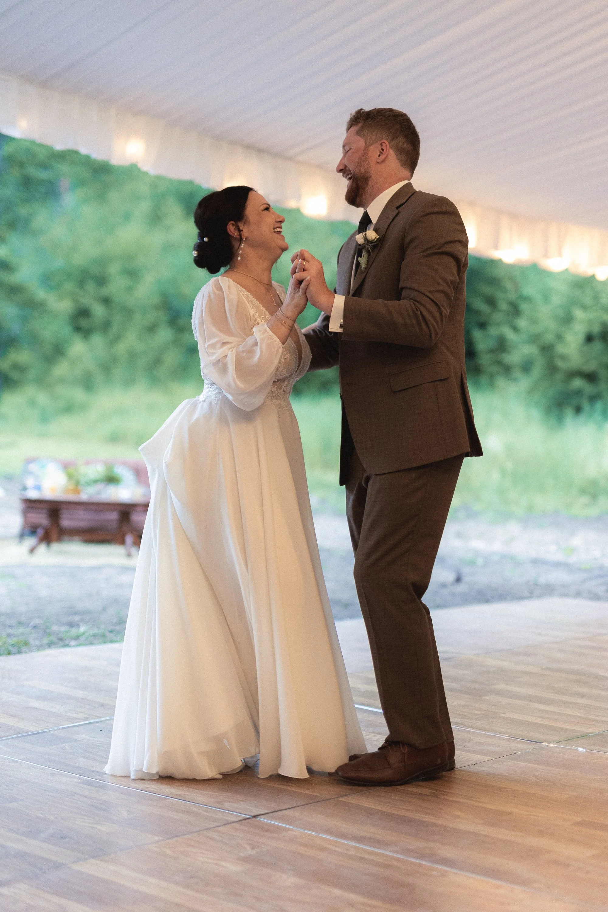 A bride and groom dancing during their wedding reception.