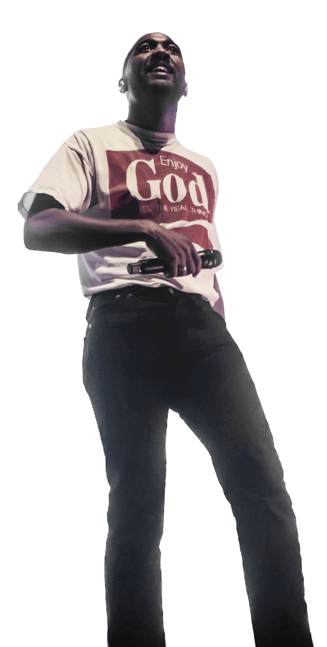 A person holding a microphone, wearing a white T-shirt with red text that says "Enjoy God," and black pants.
