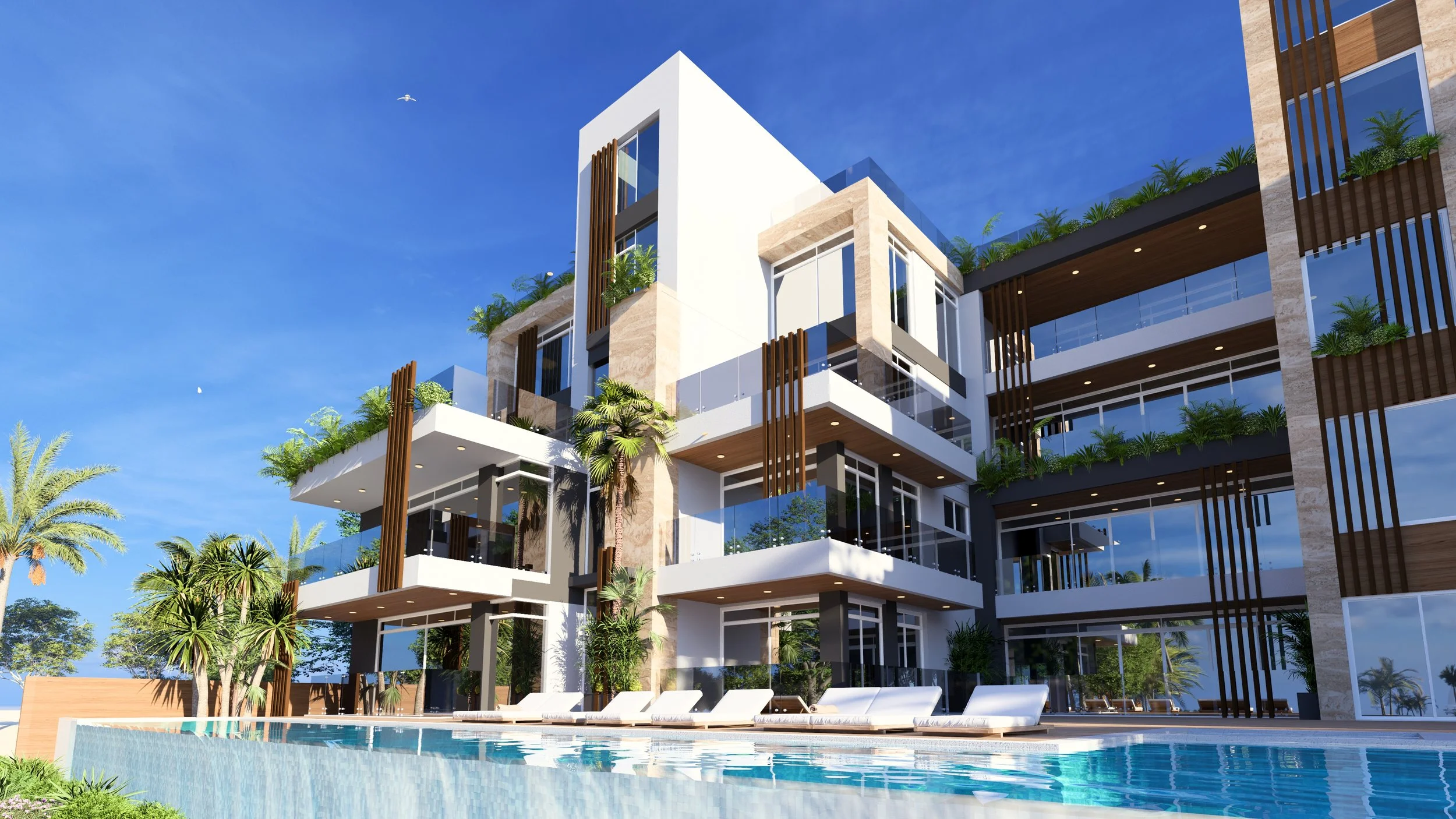 Modern multi-story apartment building with balconies, surrounded by greenery, with a swimming pool and lounge chairs in the foreground under a clear blue sky.