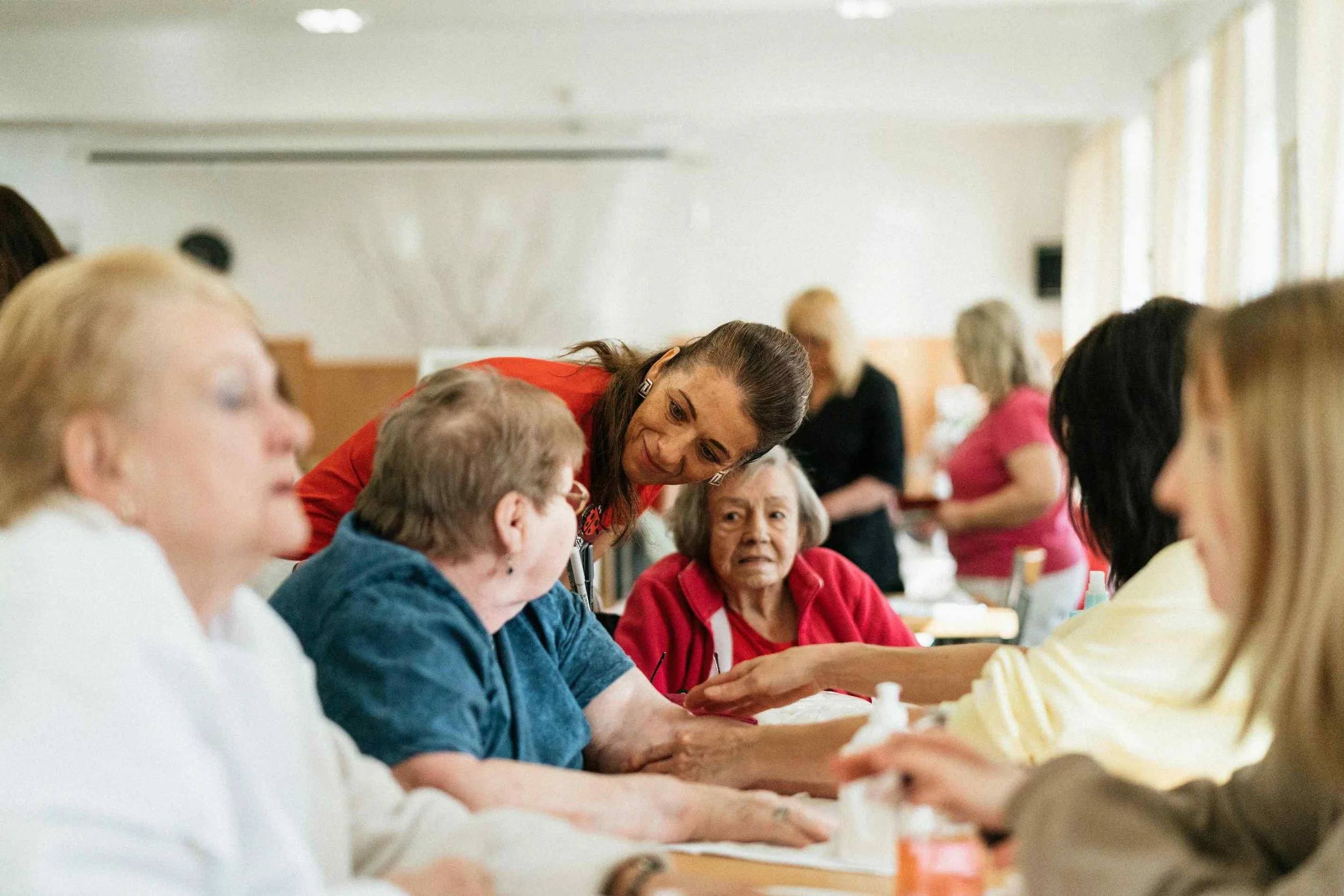 Caregiver assisting a senior with medication reminders during a home care visit