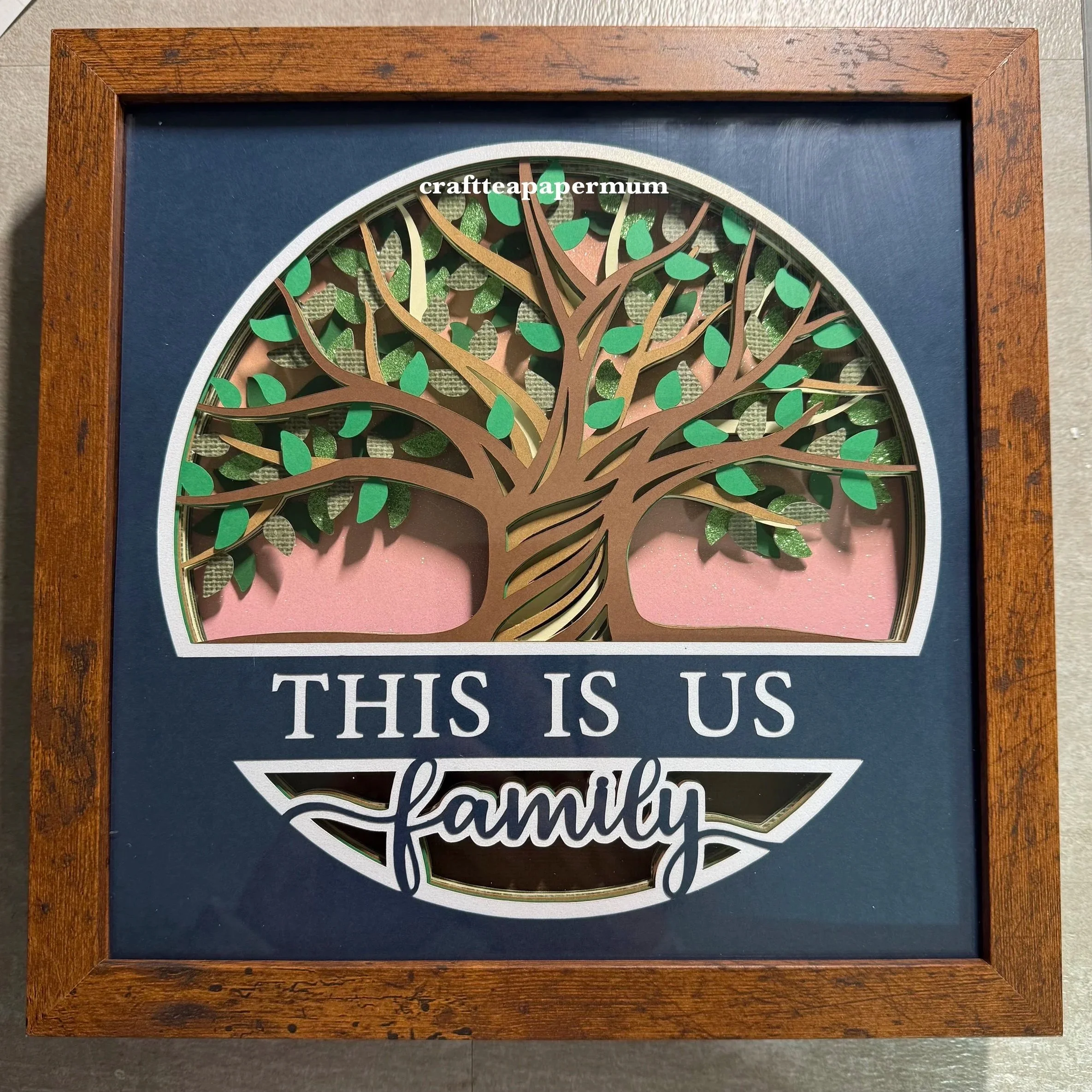 Family Tree with shades of green leaves, shades of brown tree branches, and blue top with this is us family