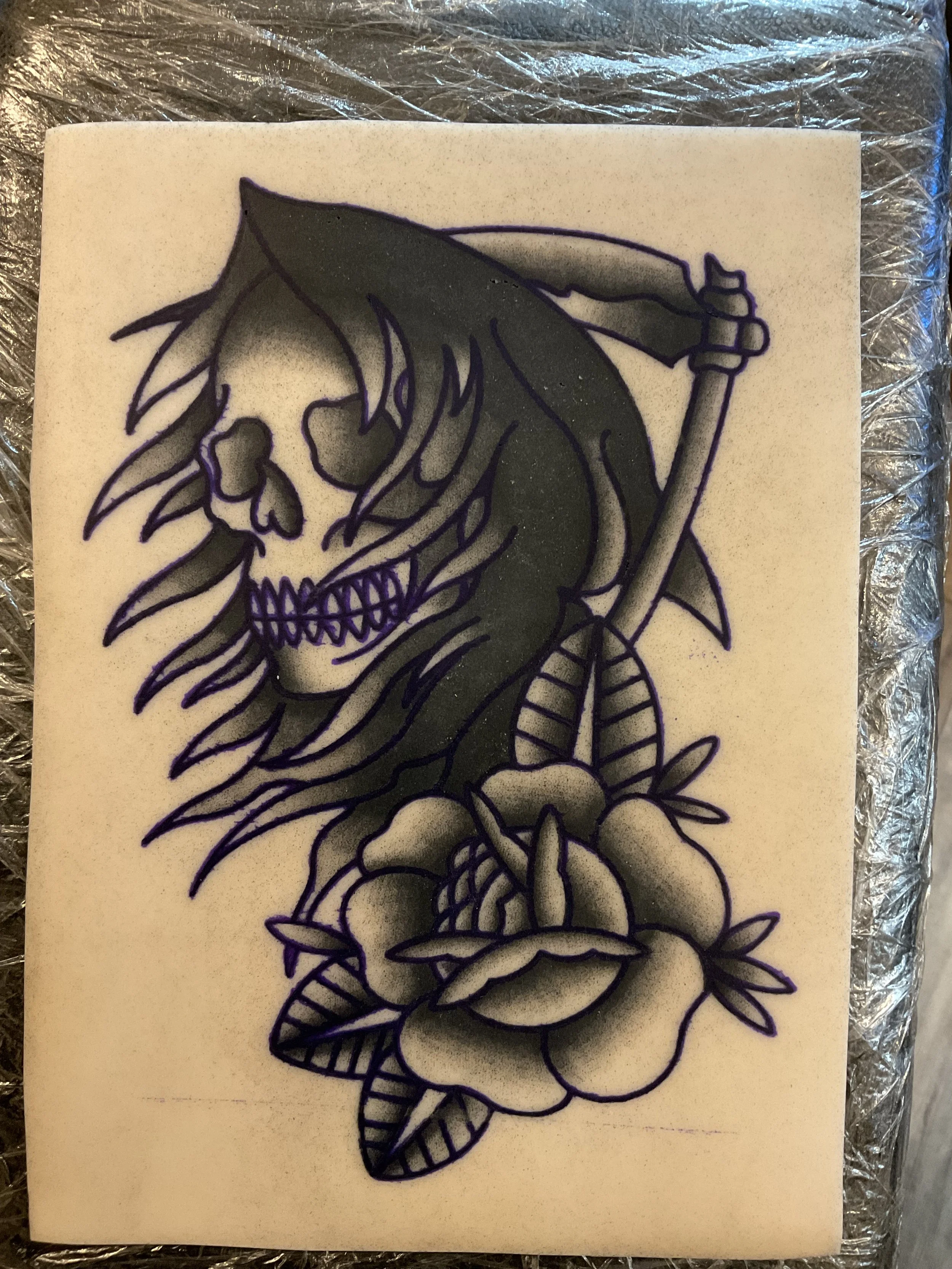Tattoo design of a Grim Reaper skeleton with long hair, holding a scythe, surrounded by roses and leaves.