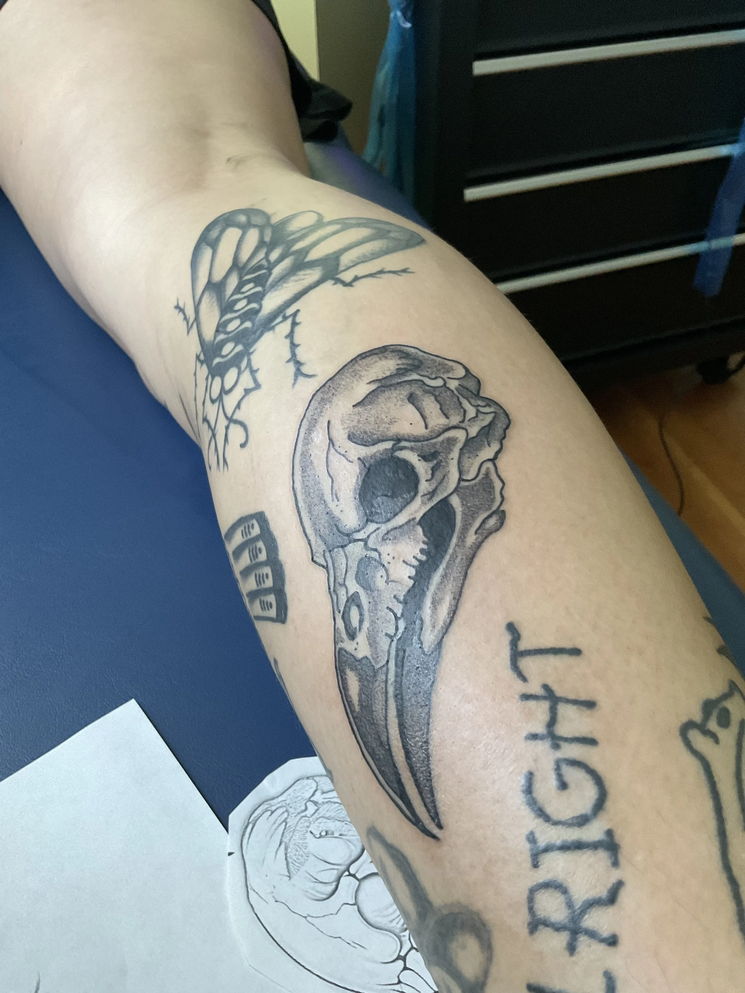 Tattoo on a person's arm featuring a skull