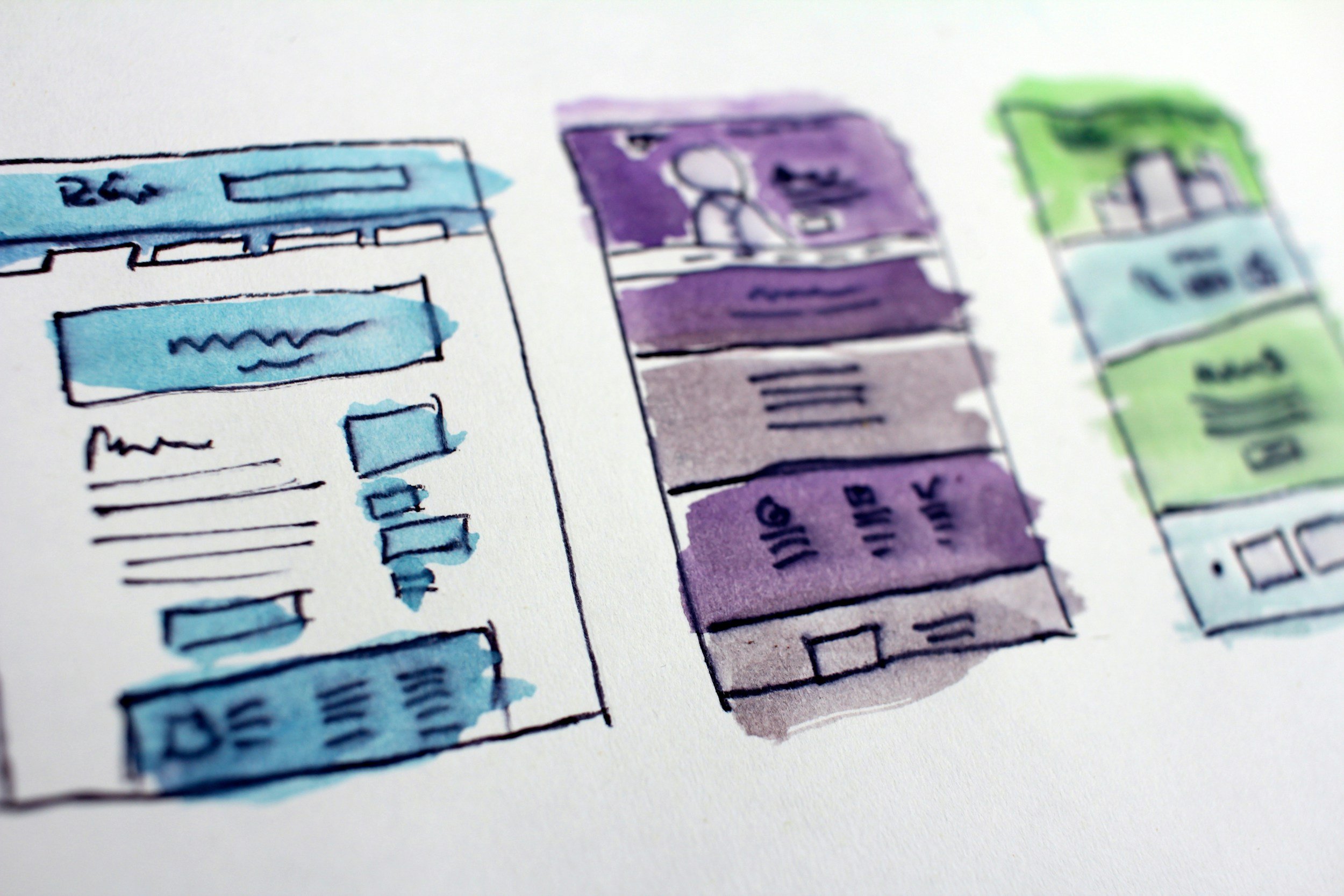 Hand-drawn and watercolor-painted sketches of three concept mobile app interface designs in blue, purple, and green colors.