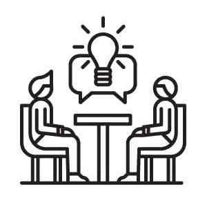 Two people sitting at a table having a discussion with a lightbulb inside a speech bubble above them, symbolizing ideas or brainstorming.
