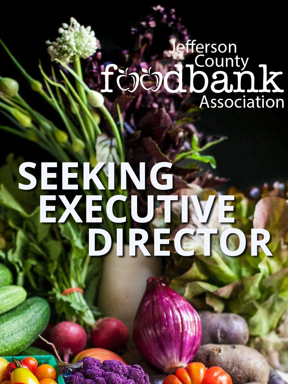 Broccoli, radishes, red onion, potatoes, tomatoes, cauliflower, and other vegetables in front of the Jefferson County Food Bank Association logo.