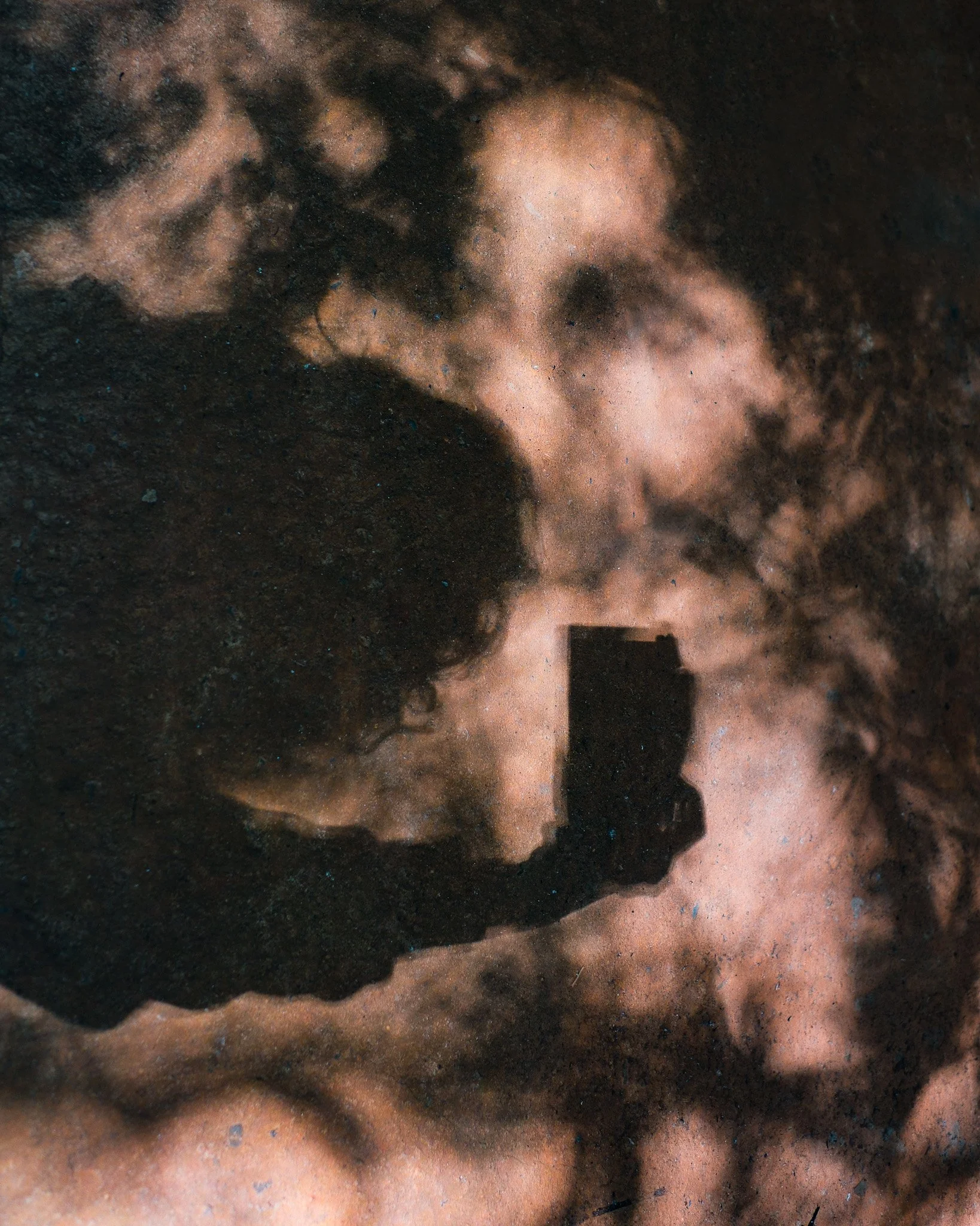 A person taking a photograph of a cloudy sky with a smartphone.