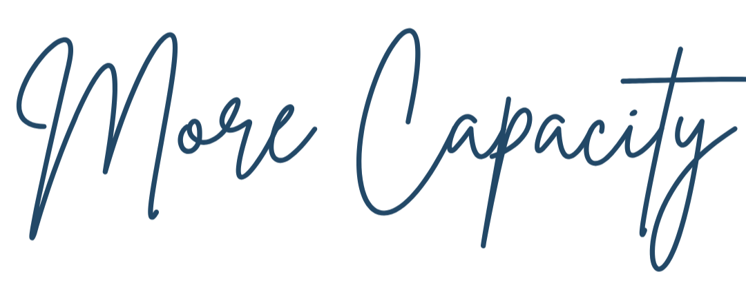 Text that reads 'More Capacity' in a cursive font with a dark blue color.