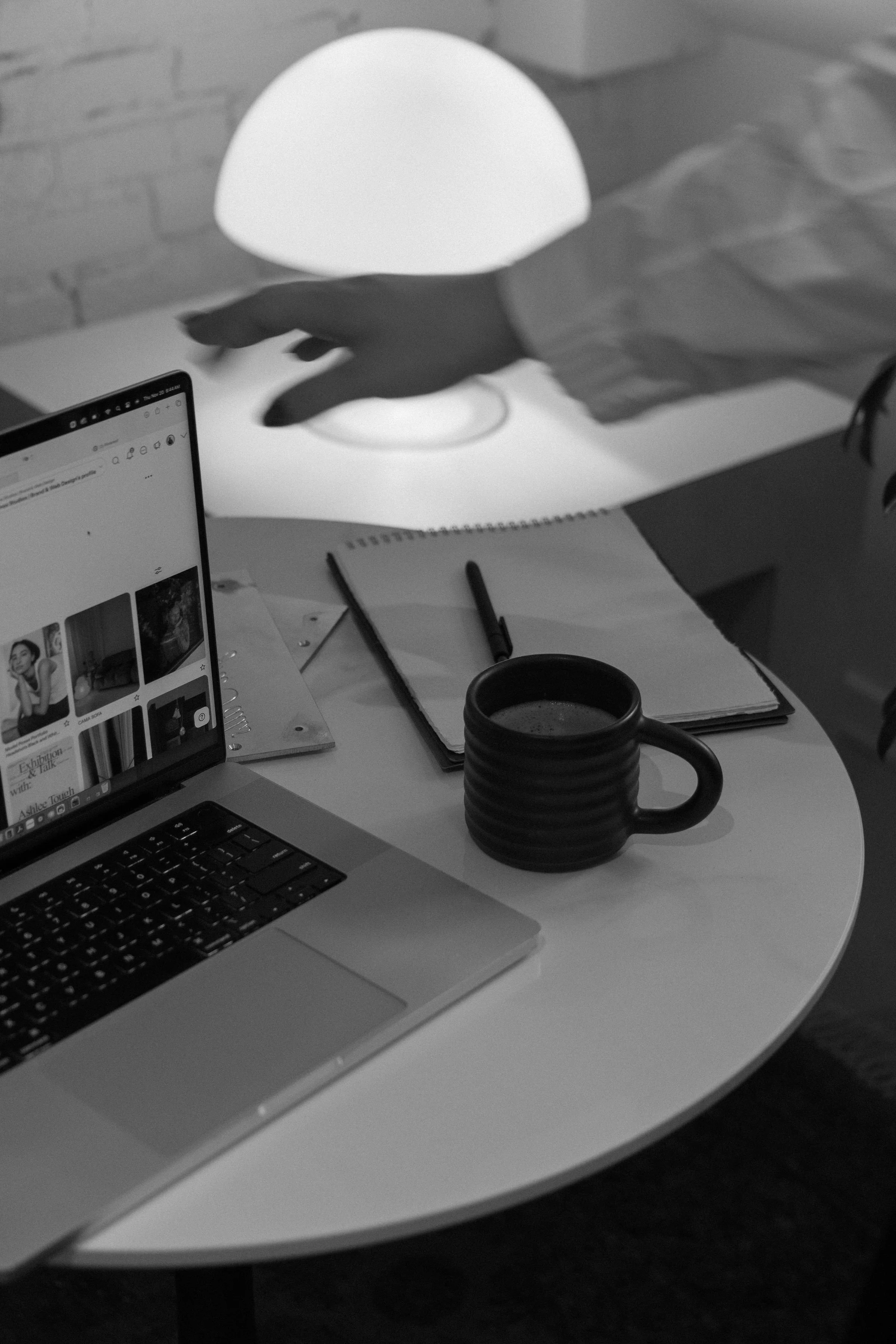 Black and white image of computer being closed.