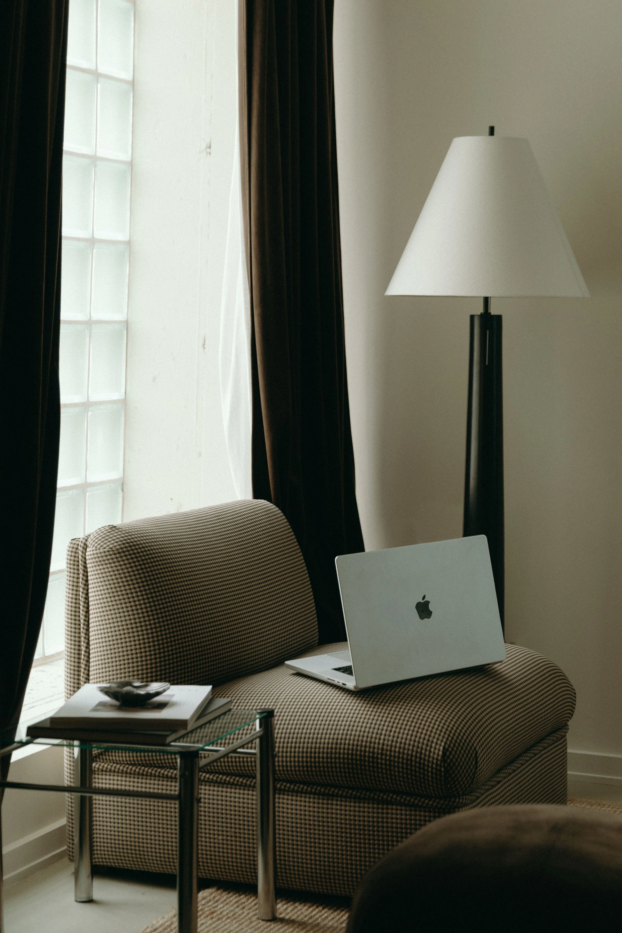 Computer sitting on lounge chair.