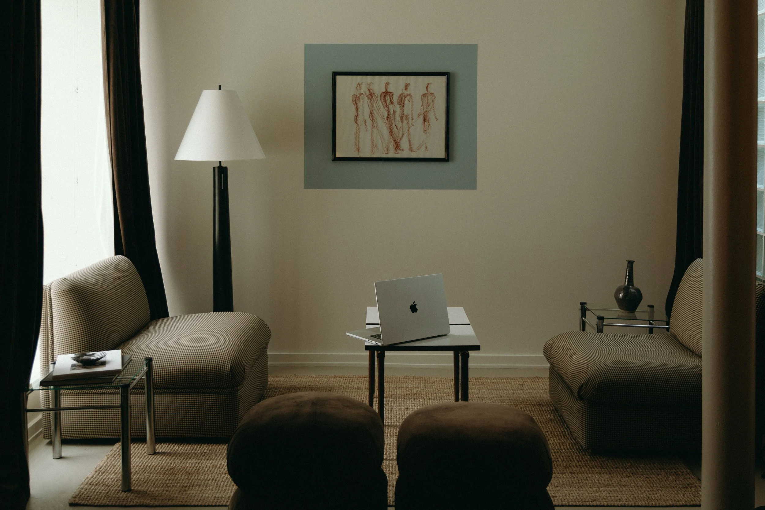 Computer on small table with lounge chairs.