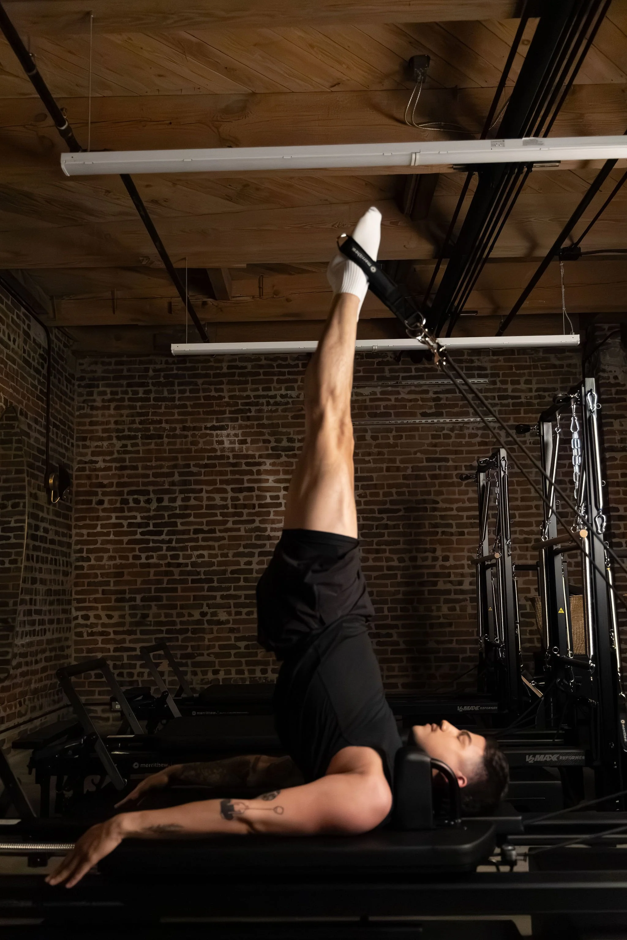 Man using pilates reformer.