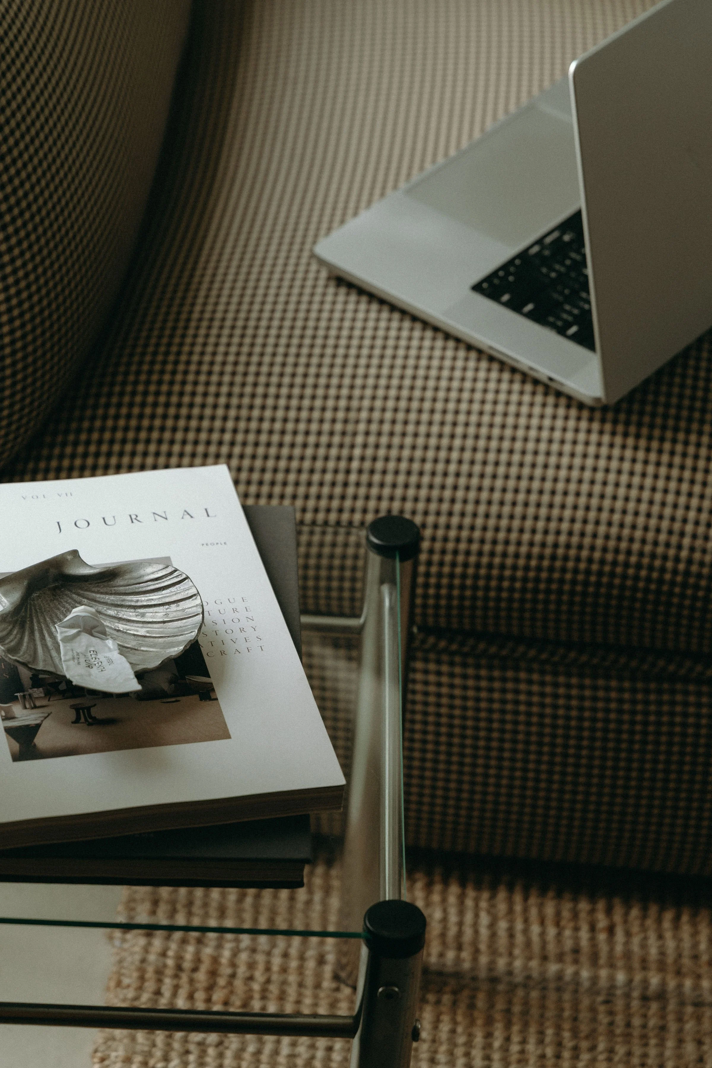 Silver sea shell dish on magazine.