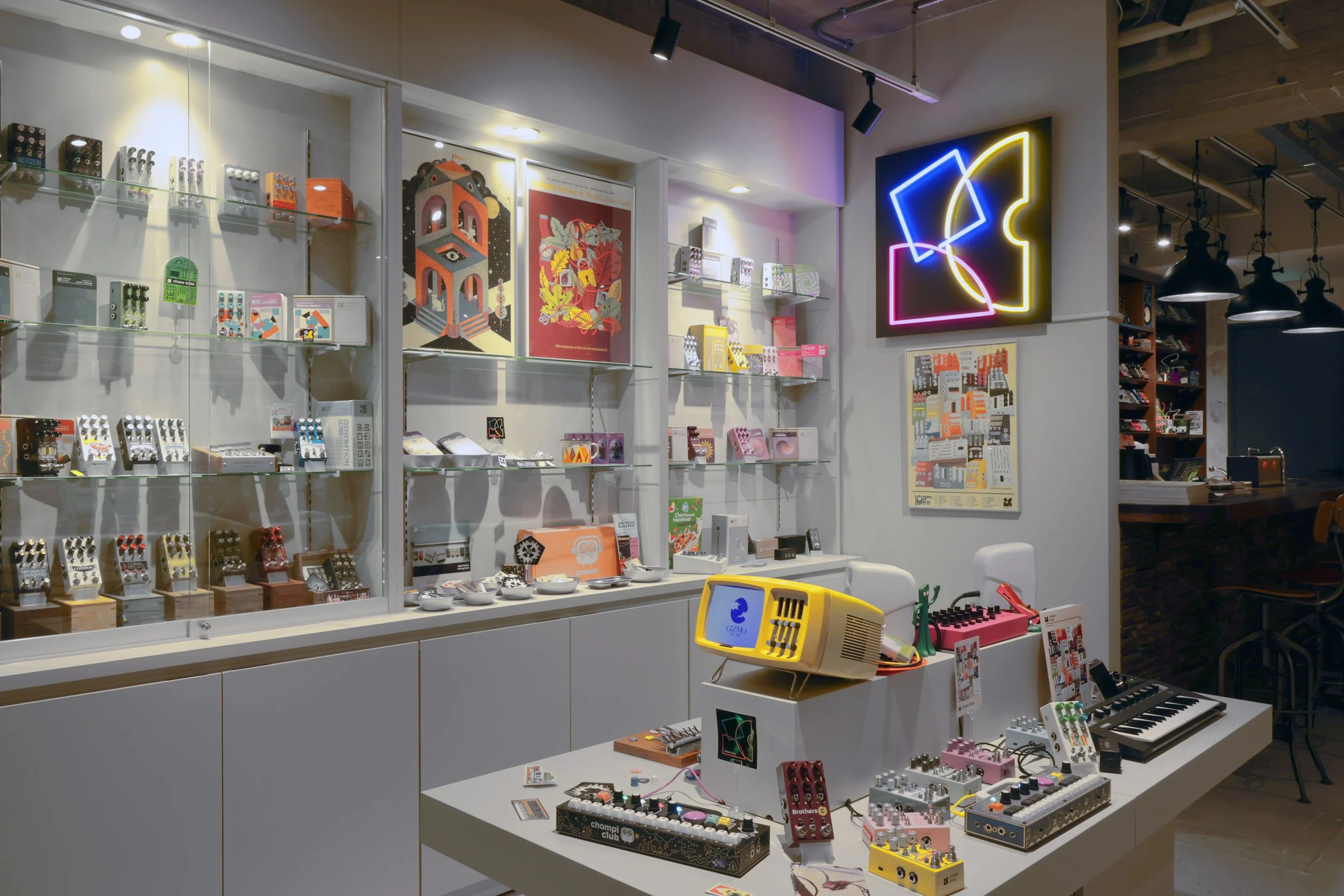Wide shot of various Chase Bliss effects pedals and merchandise at Gizmo Music.