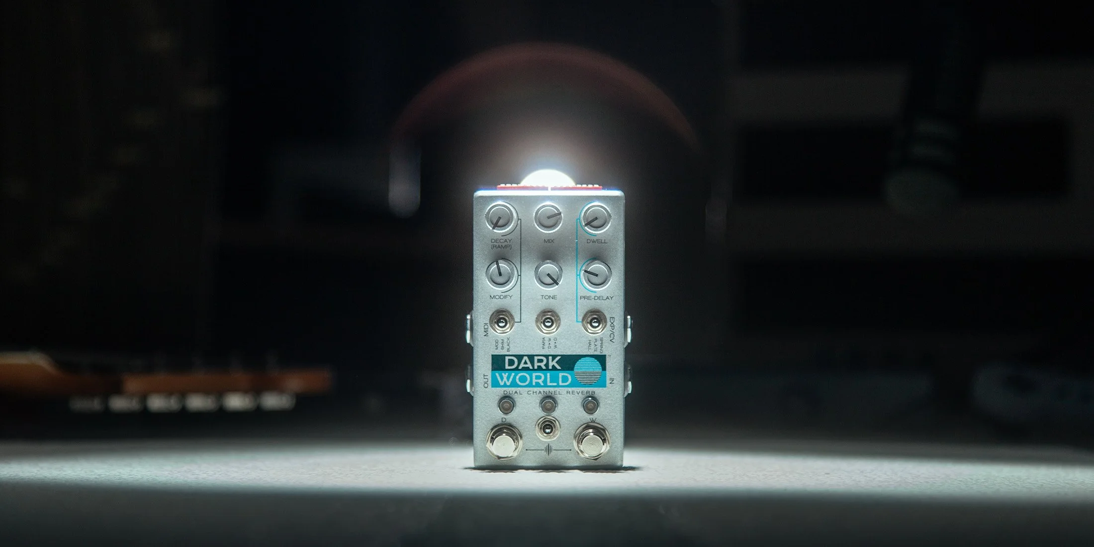 Dark World pedal in a dark room with a spotlight.
