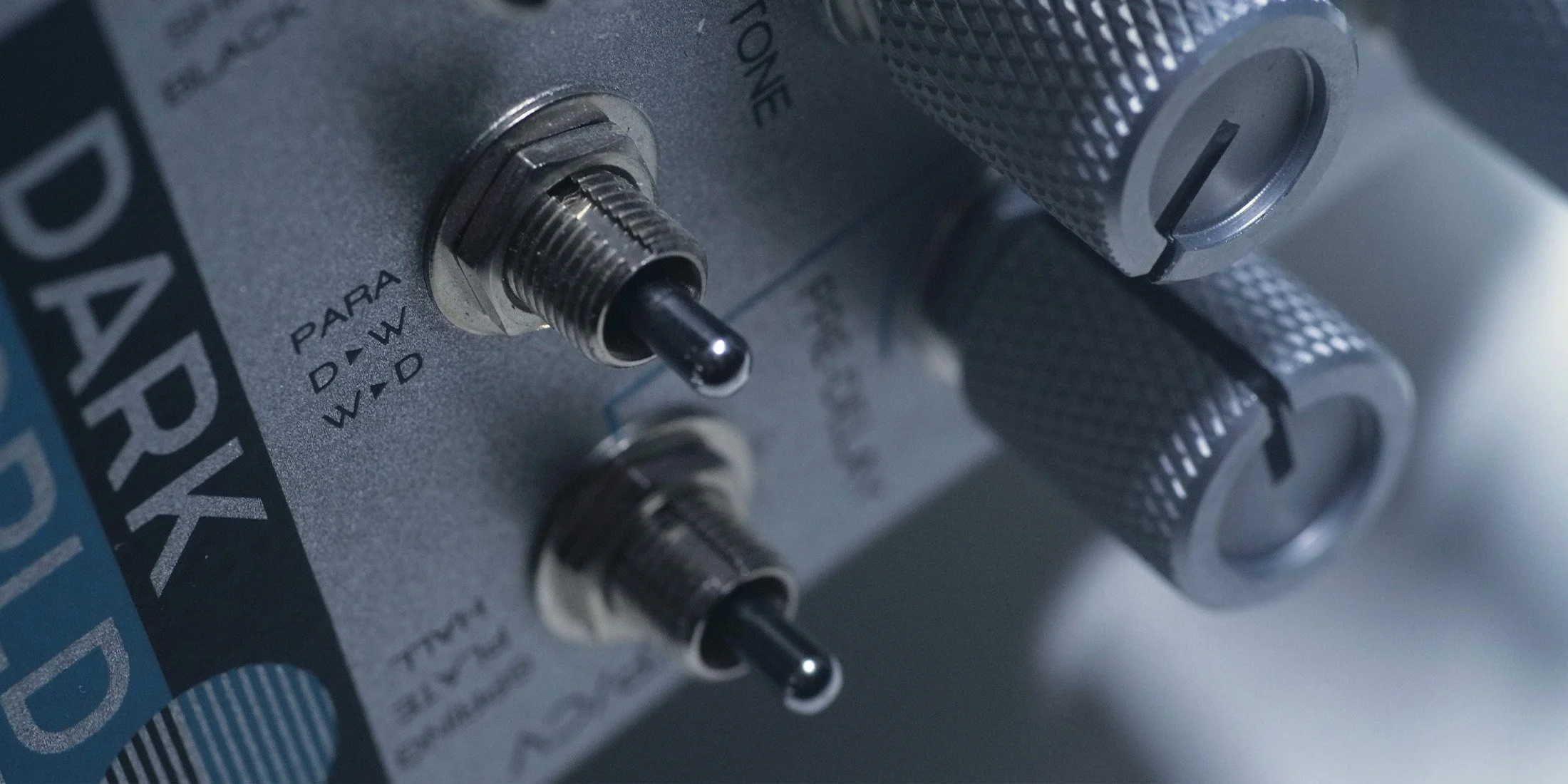 Dark World pedal with switches and knobs highlighted.